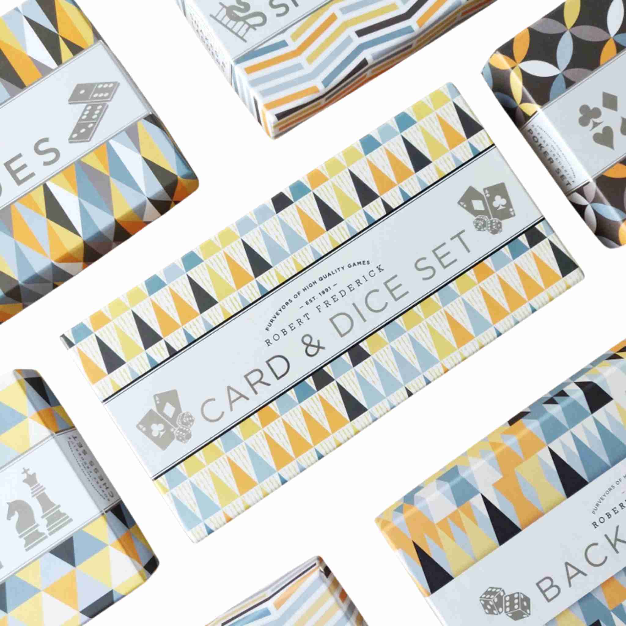 Card and dice set packaging with geometric patterns on a white background