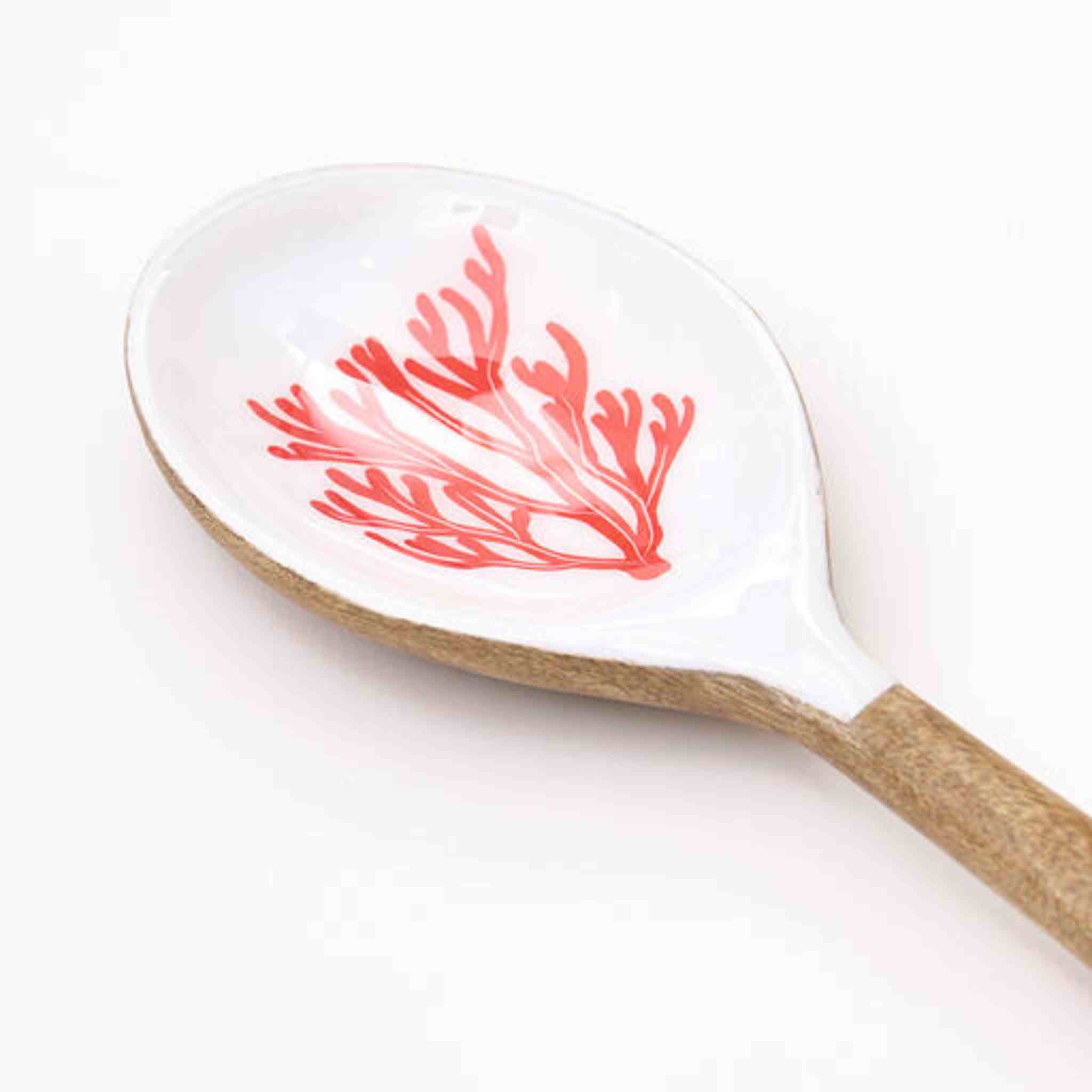 Spoon with red seaweed design on a white background