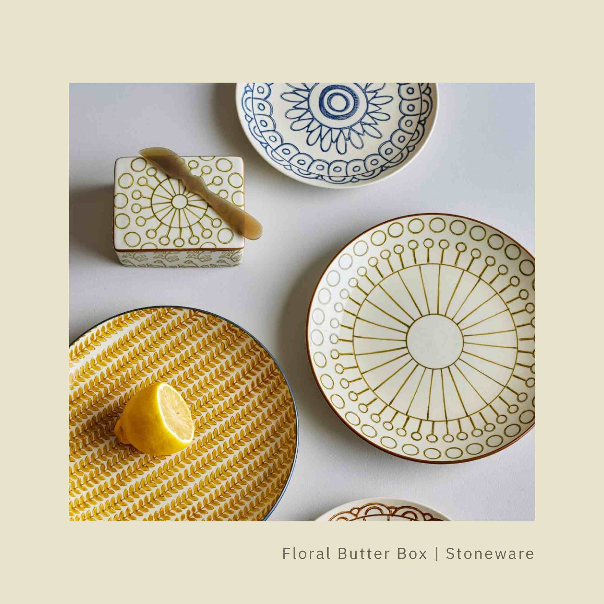 Collection of stoneware plates with decorative patterns on a light background