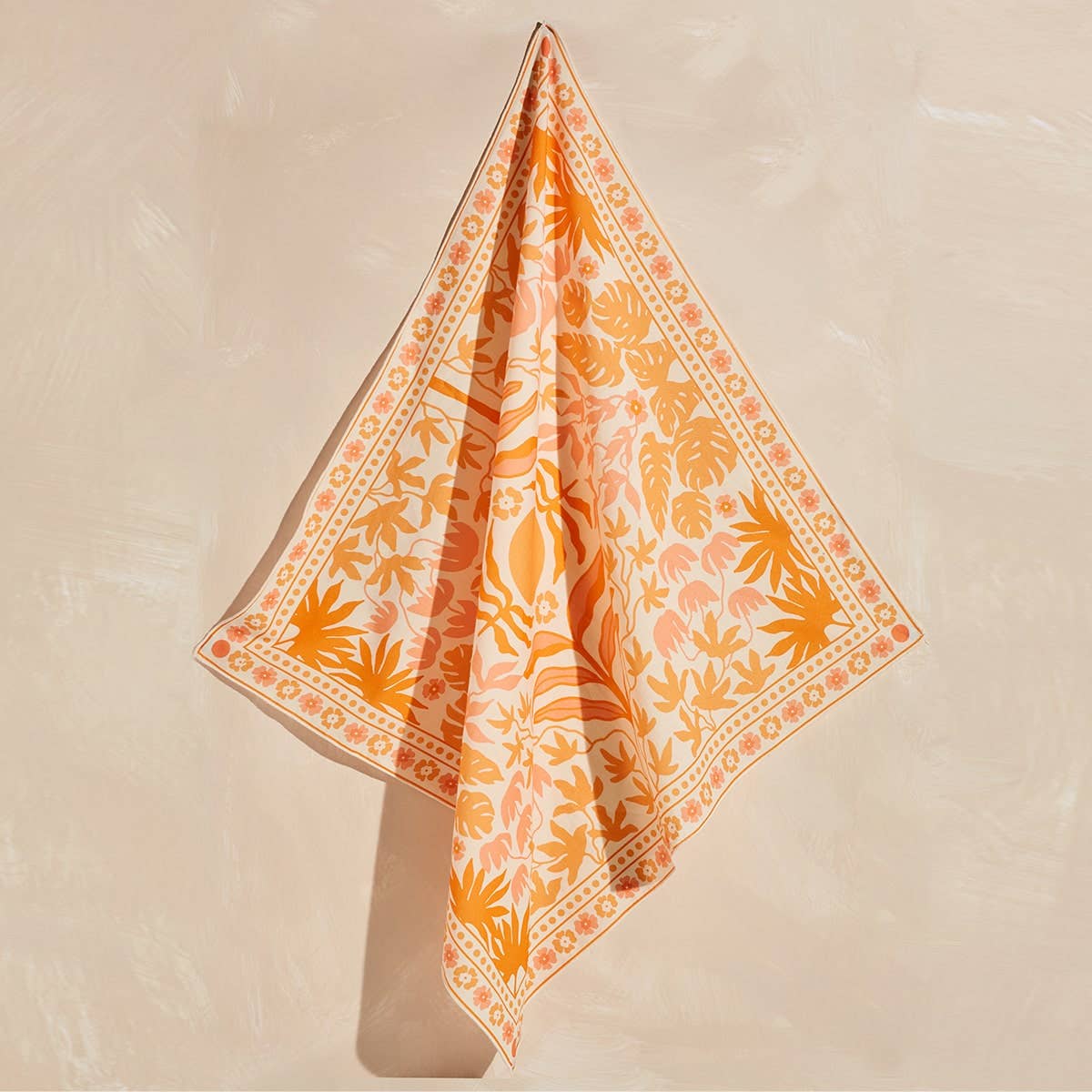 Orange and white patterned fabric on a beige background