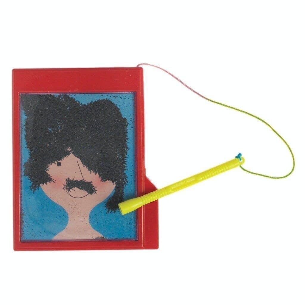 Small book with a portrait of a person with a mustache and black hair, attached to a yellow string on a white background.