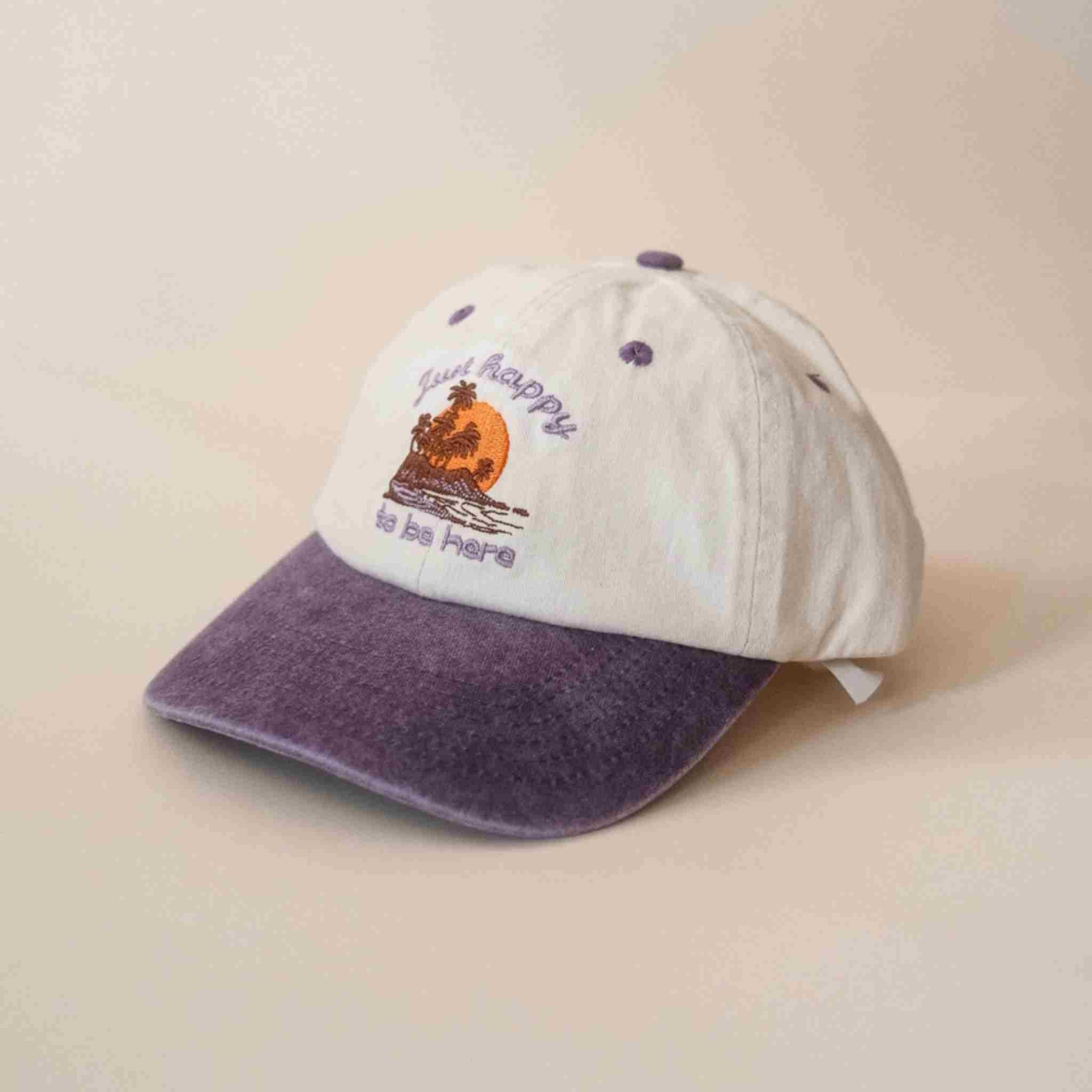 White and purple cap with a design and text on a beige background