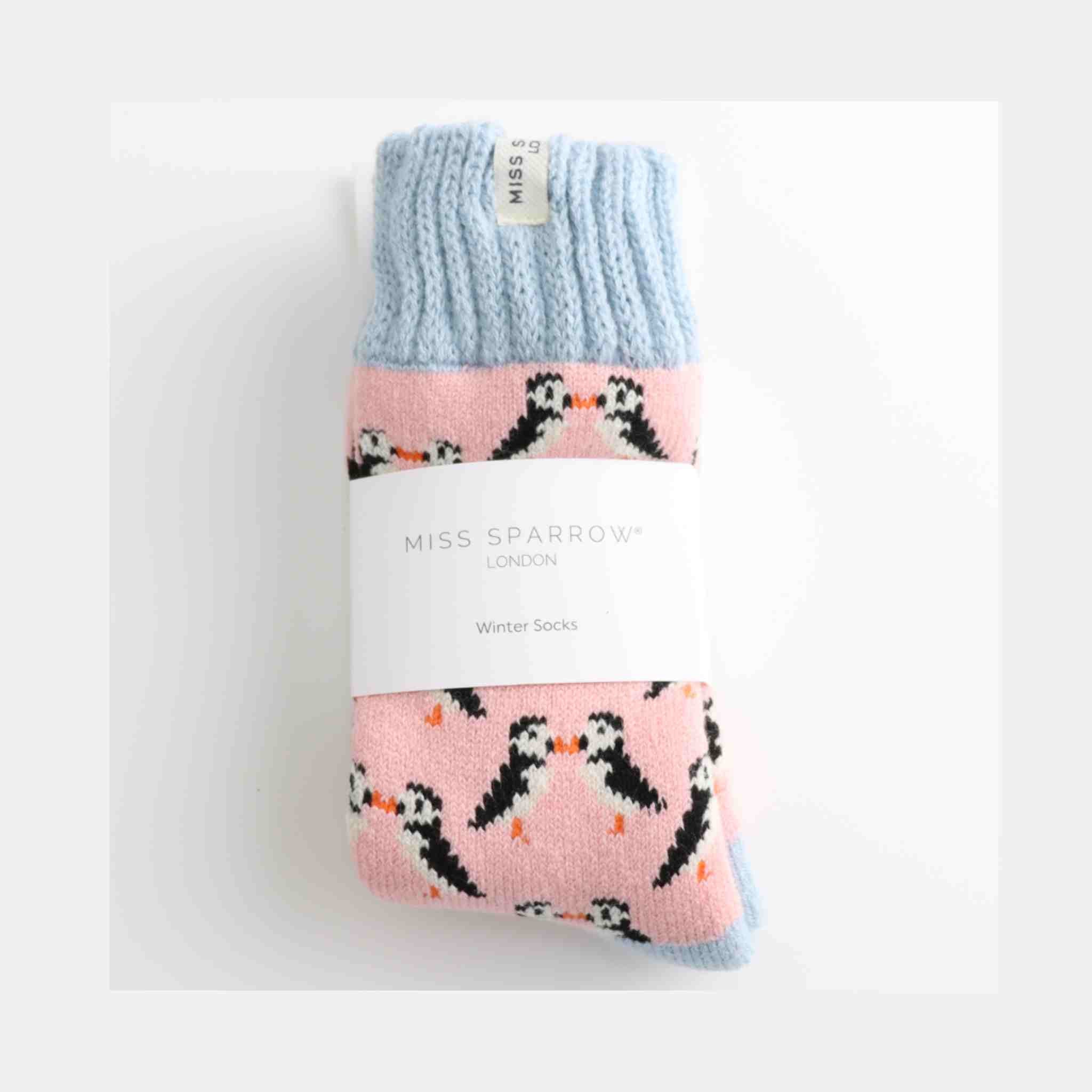 Pack of pink socks with puffin design and light blue top, on a white background
