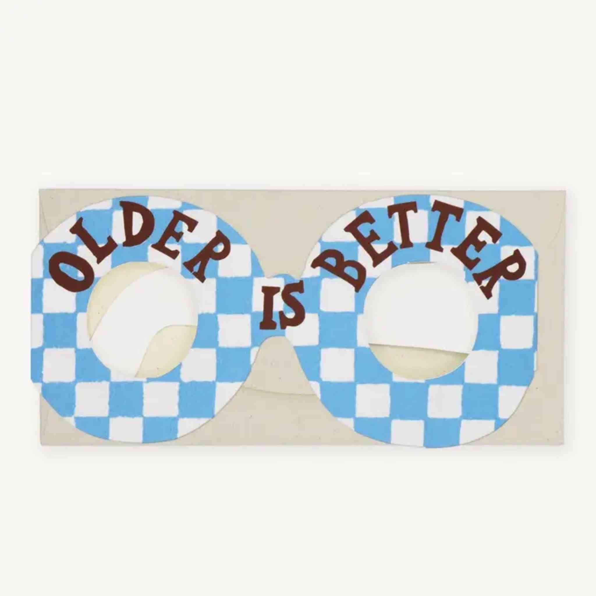 A novelty pair of novelty glasses with a blue and white checkered pattern, featuring the words 'OLDER IS BETTER'