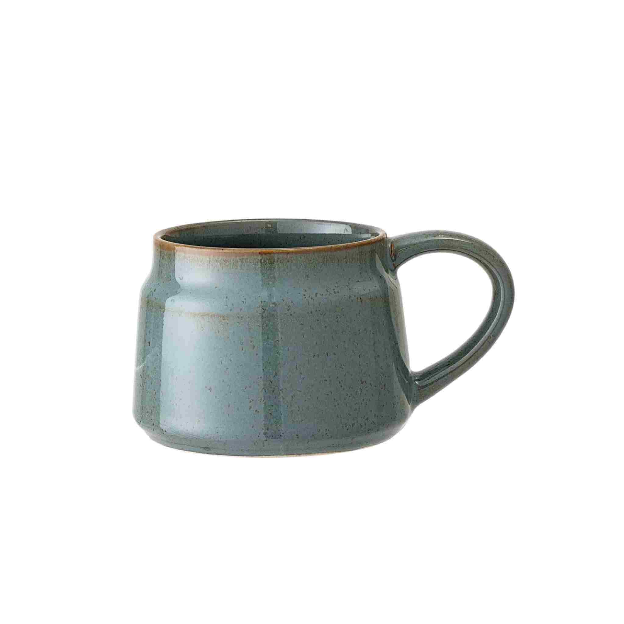 Green ceramic mug on a white background