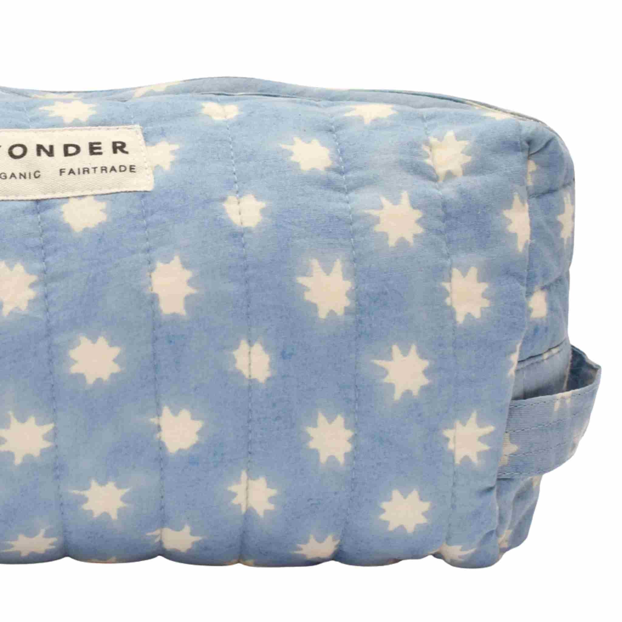 Blue pouch with white star pattern and Wonder Organic Fairtrade label on a white background