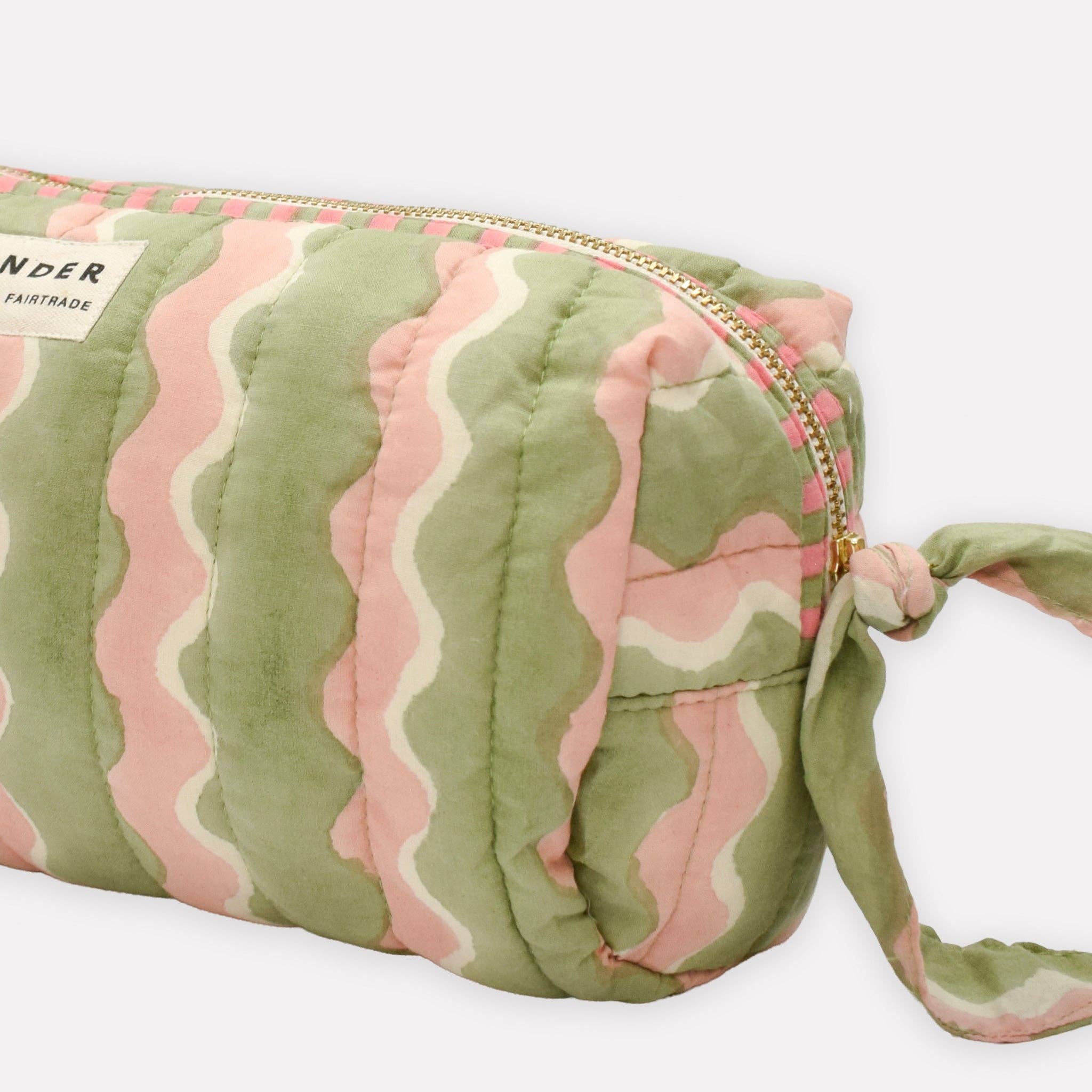 Green and pink patterned pouch with a visible brand label on a white background