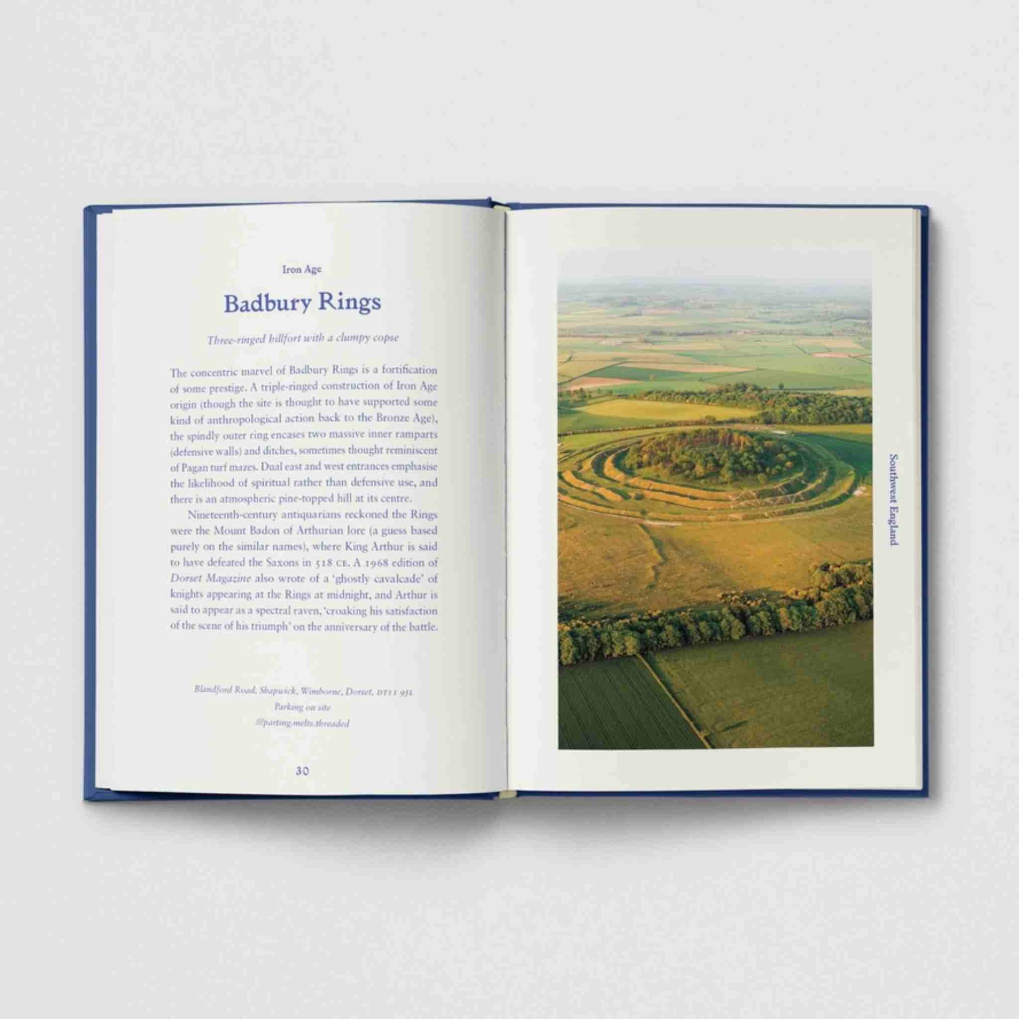 Open book with text and an image of Badbury Rings on a white background