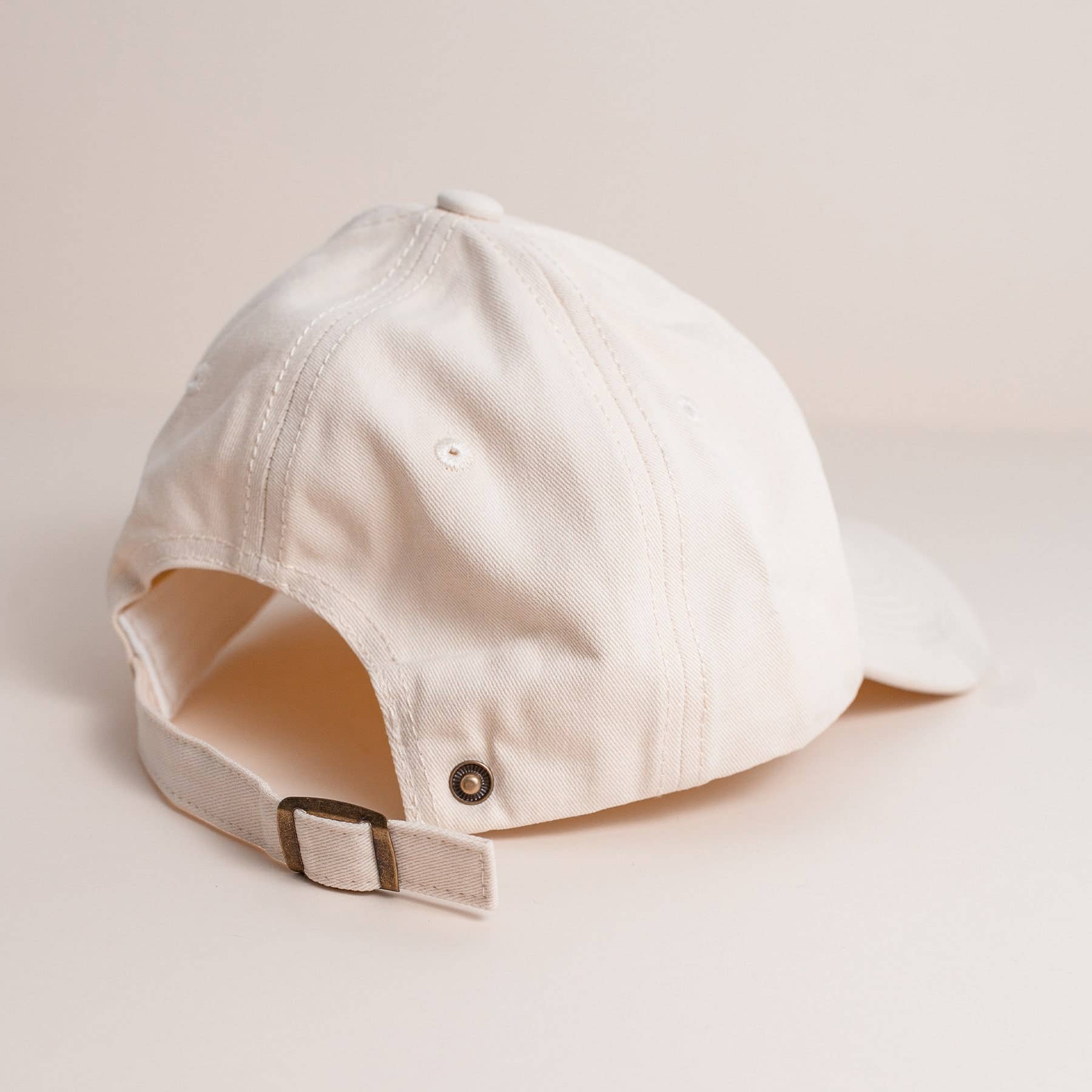 Beige baseball cap on a light beige background