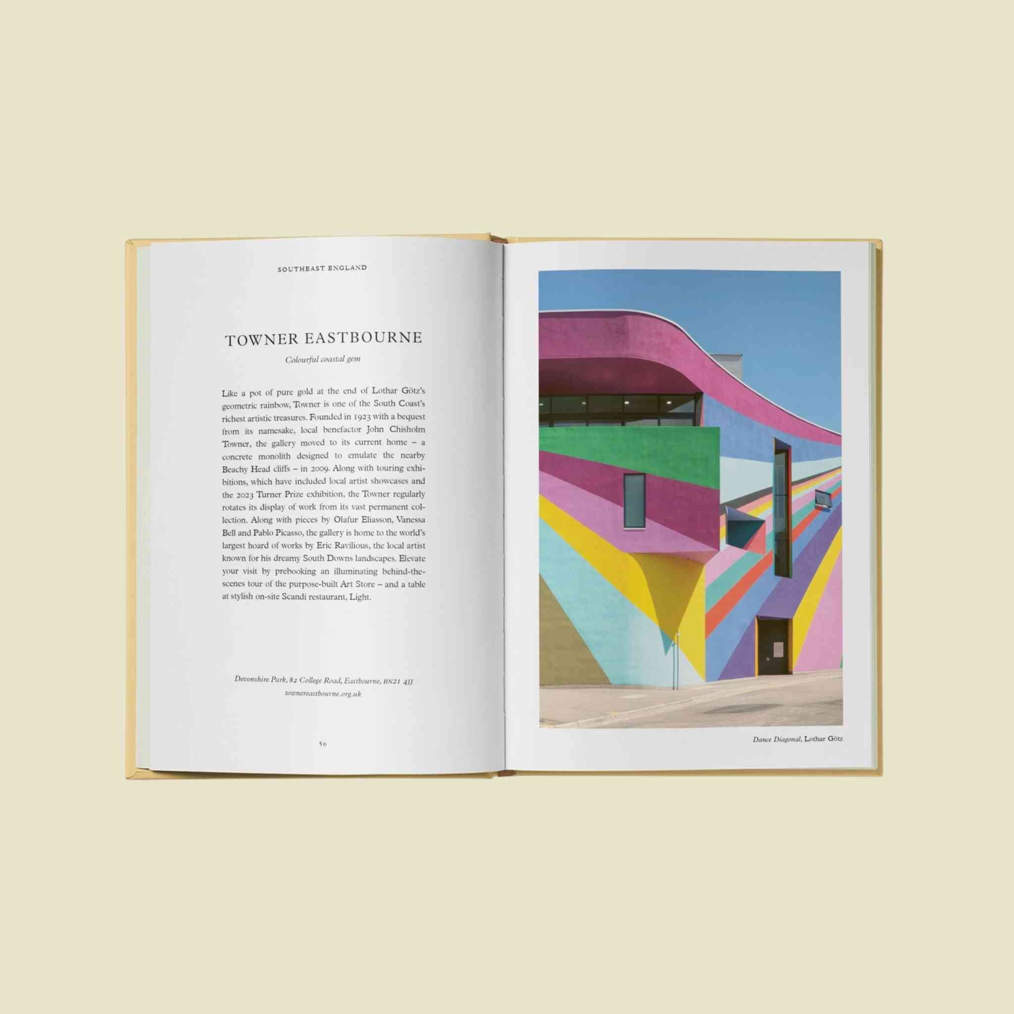 Open book with text and a colorful architectural photograph on a light yellow background
