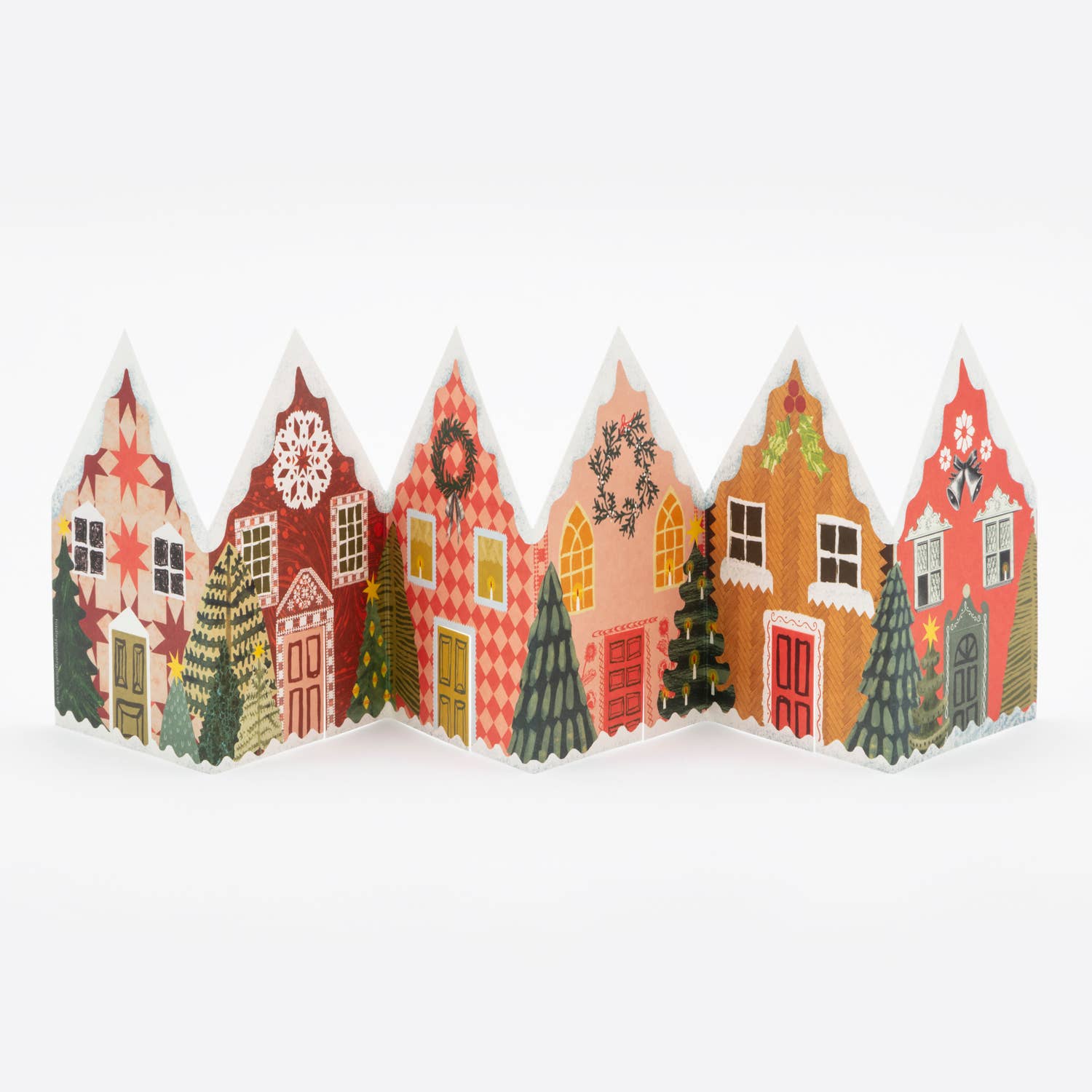 Decorative paper houses with Christmas trees on a white background