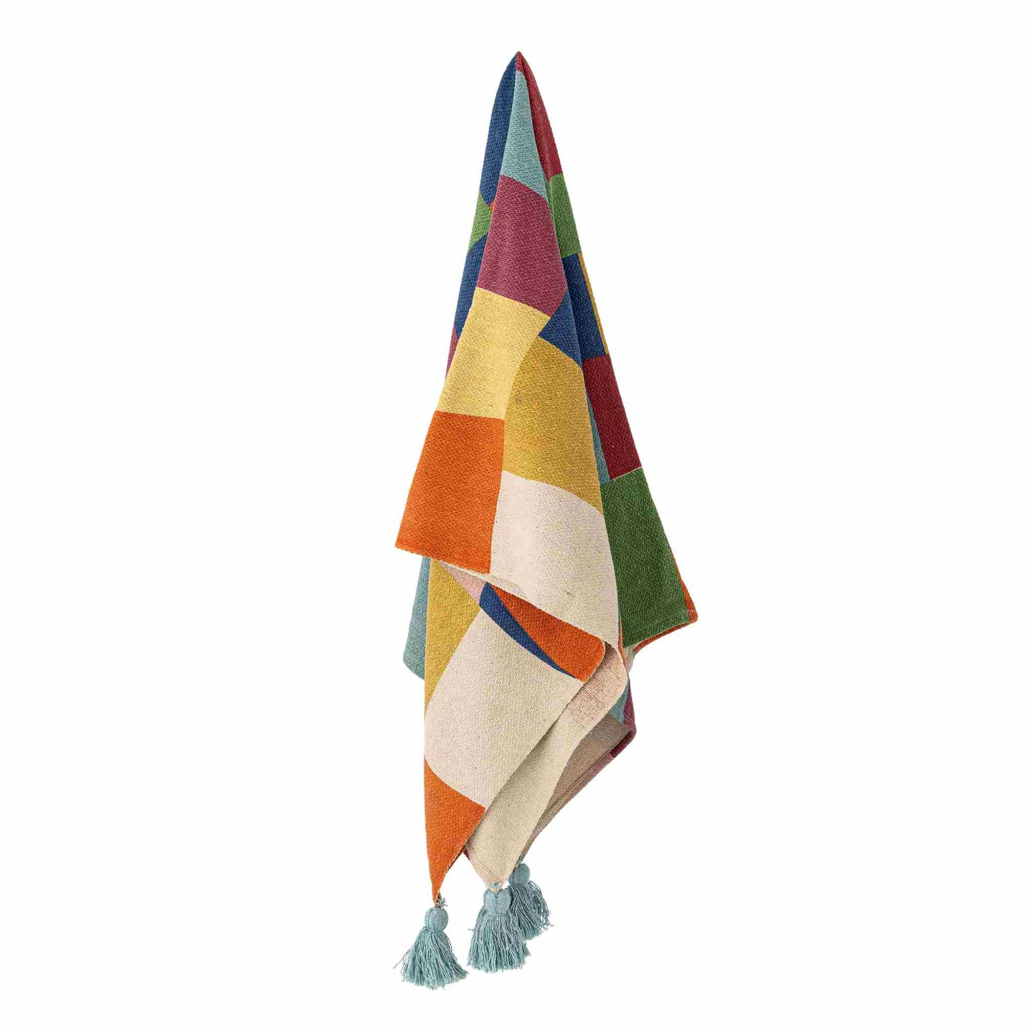 Colorful patterned blanket with tassels on a white background
