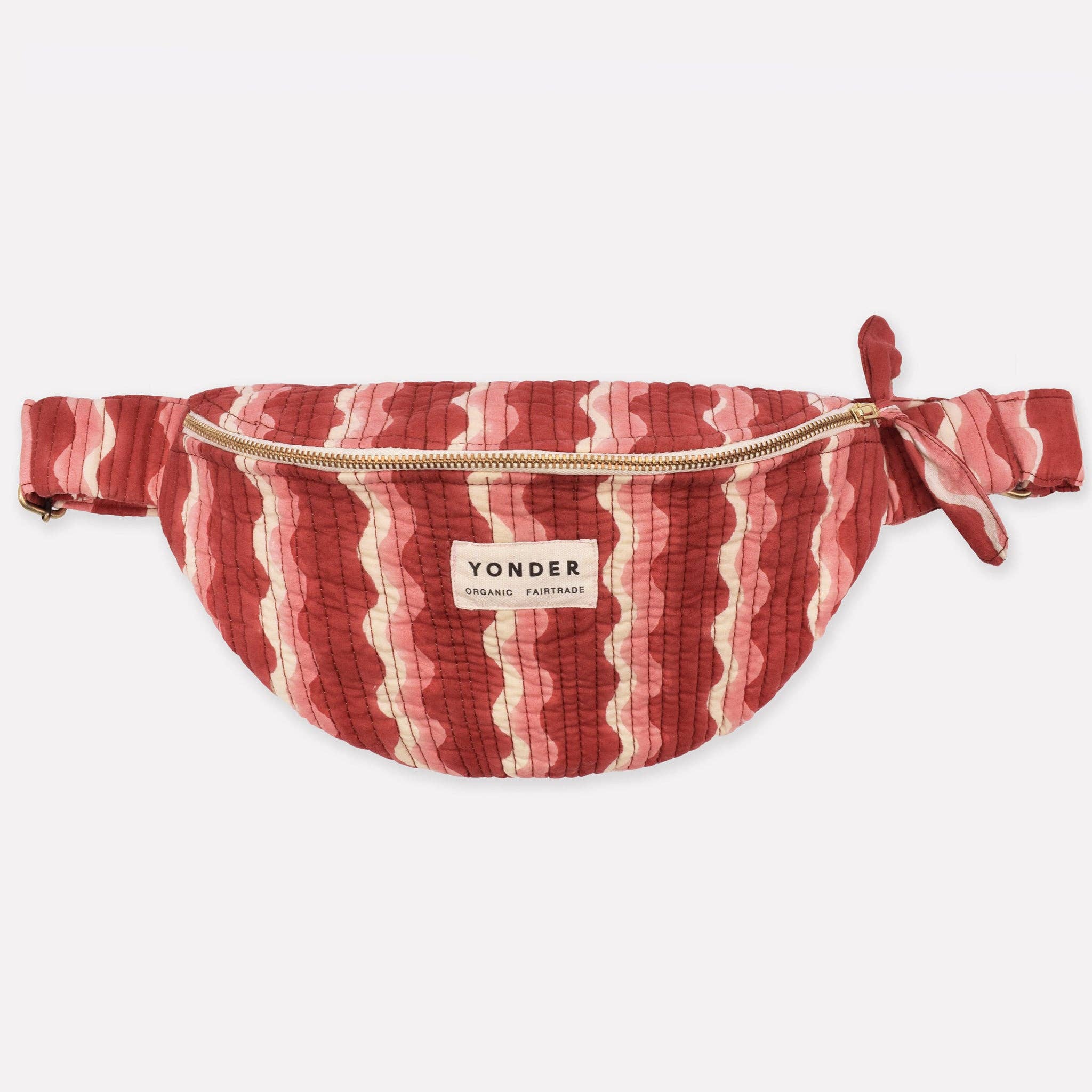Red and white striped fanny pack with 'Yonder' brand label on a white background