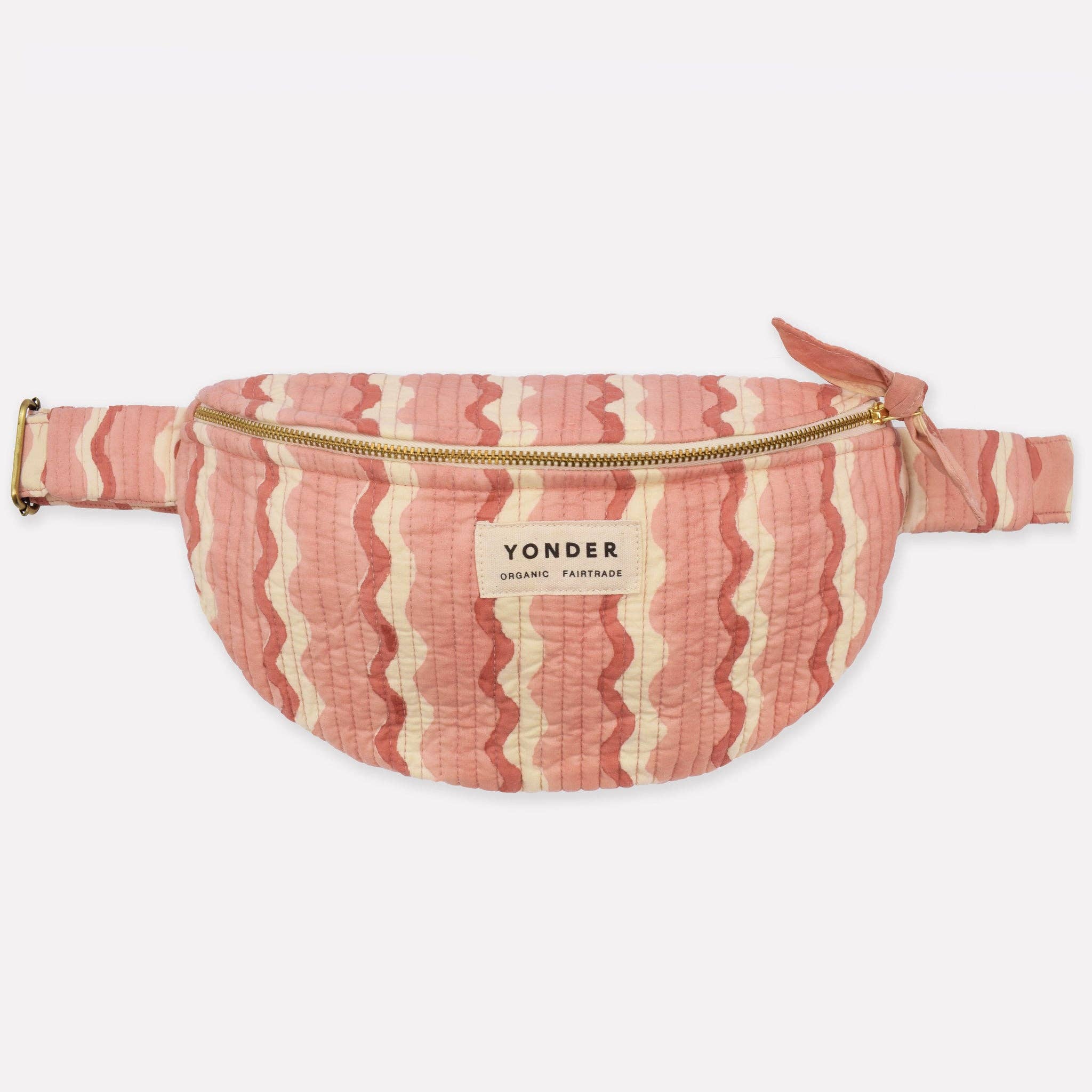 Pink and white striped fanny pack with 'Yonder' label on a light gray background