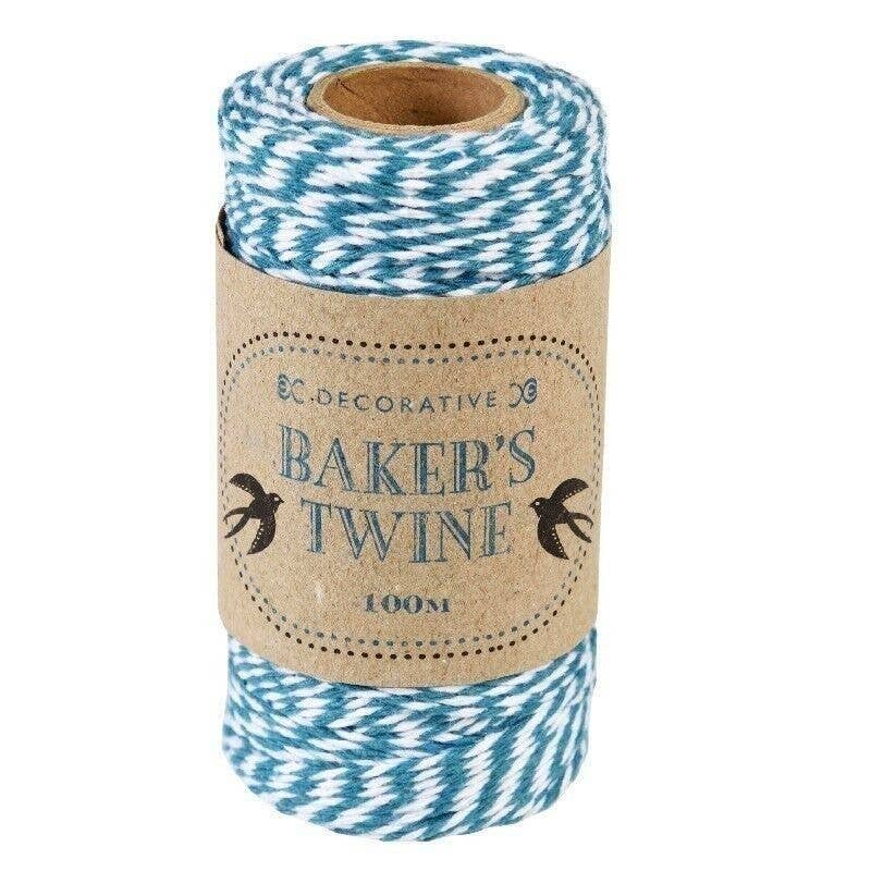 Roll of blue and white baker's twine with a decorative label on a white background