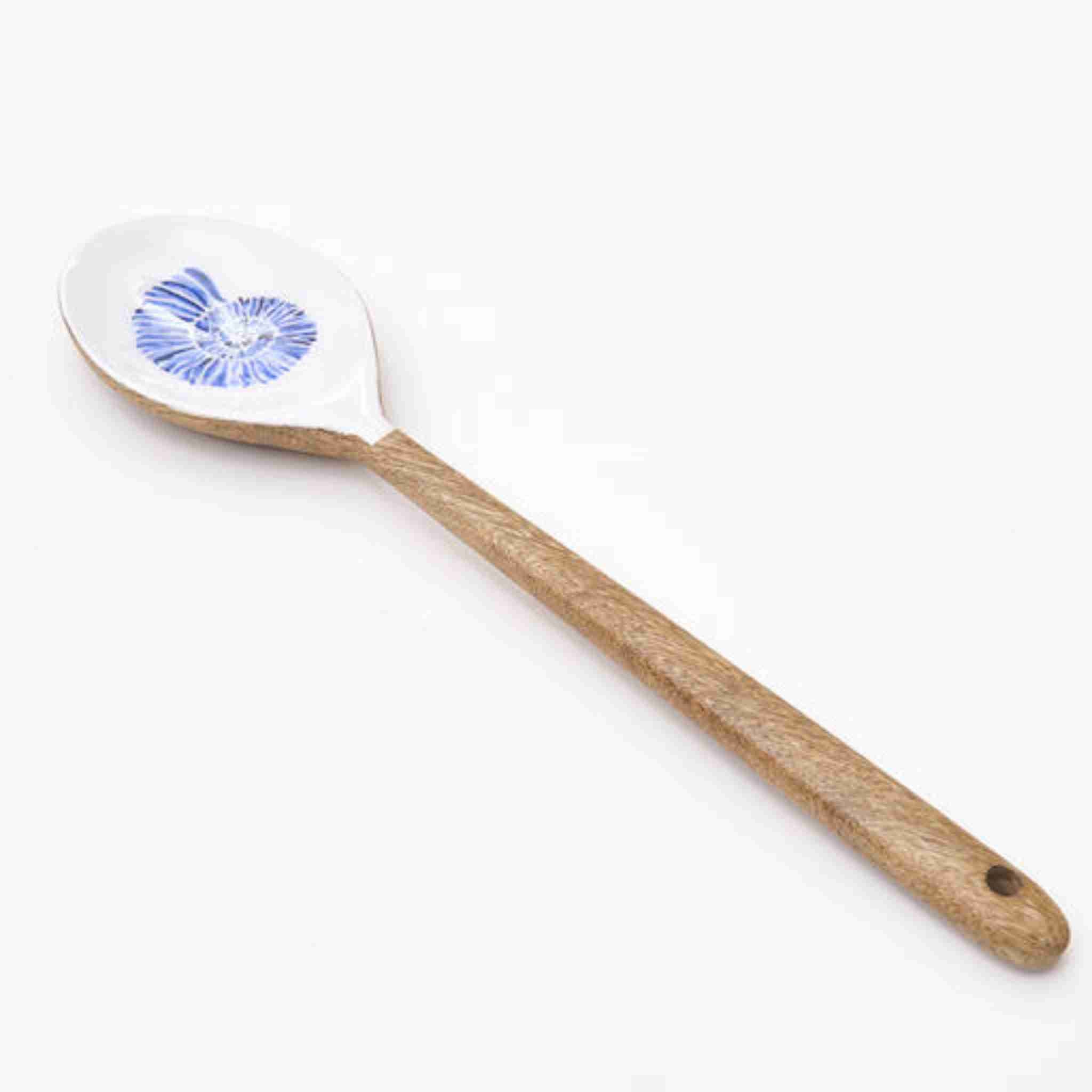 Spatula with wooden handle and white head featuring a blue shell design on a white background