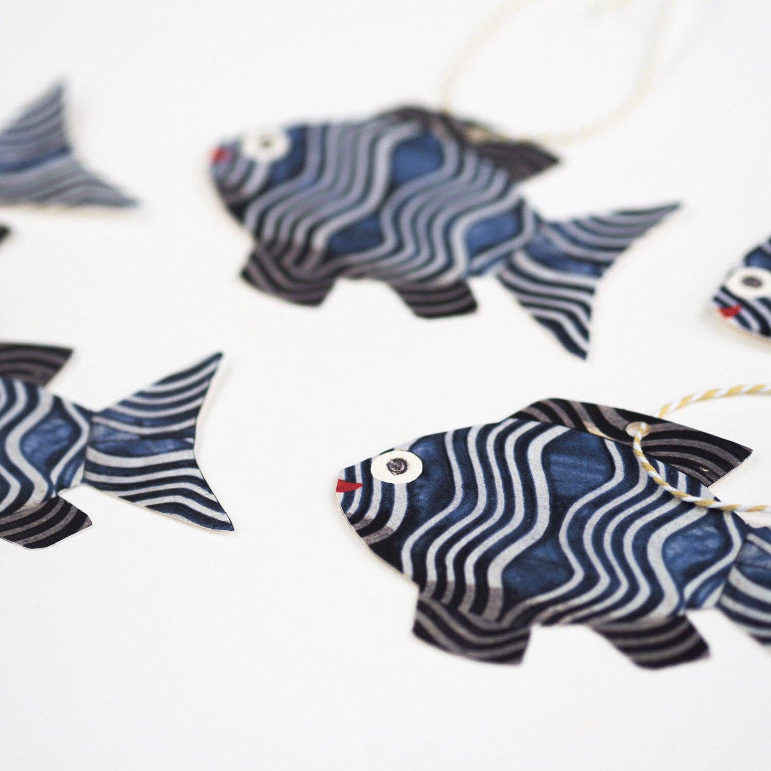Decorative fish ornaments with blue and white patterns on a white background