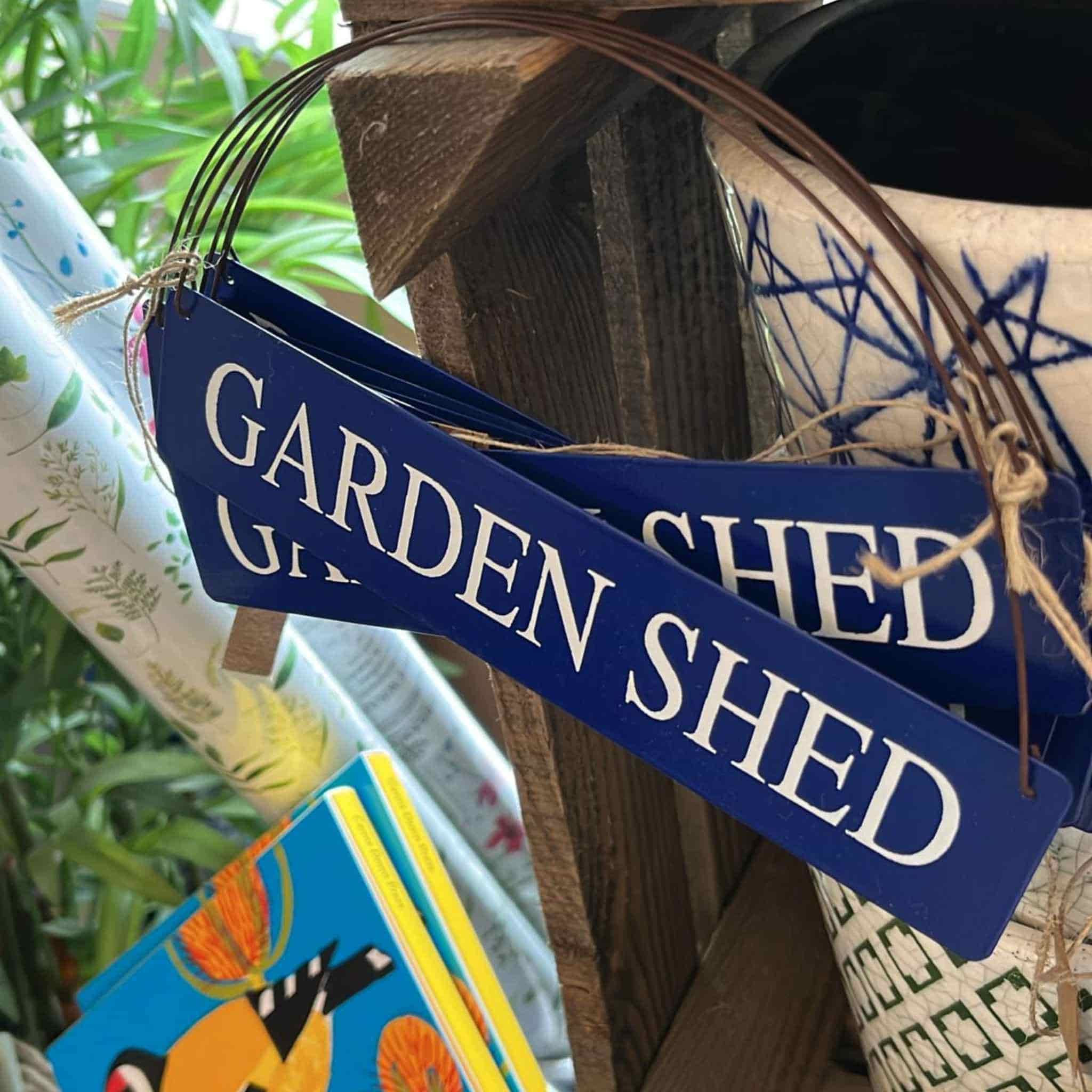 blue metal garden shed sign