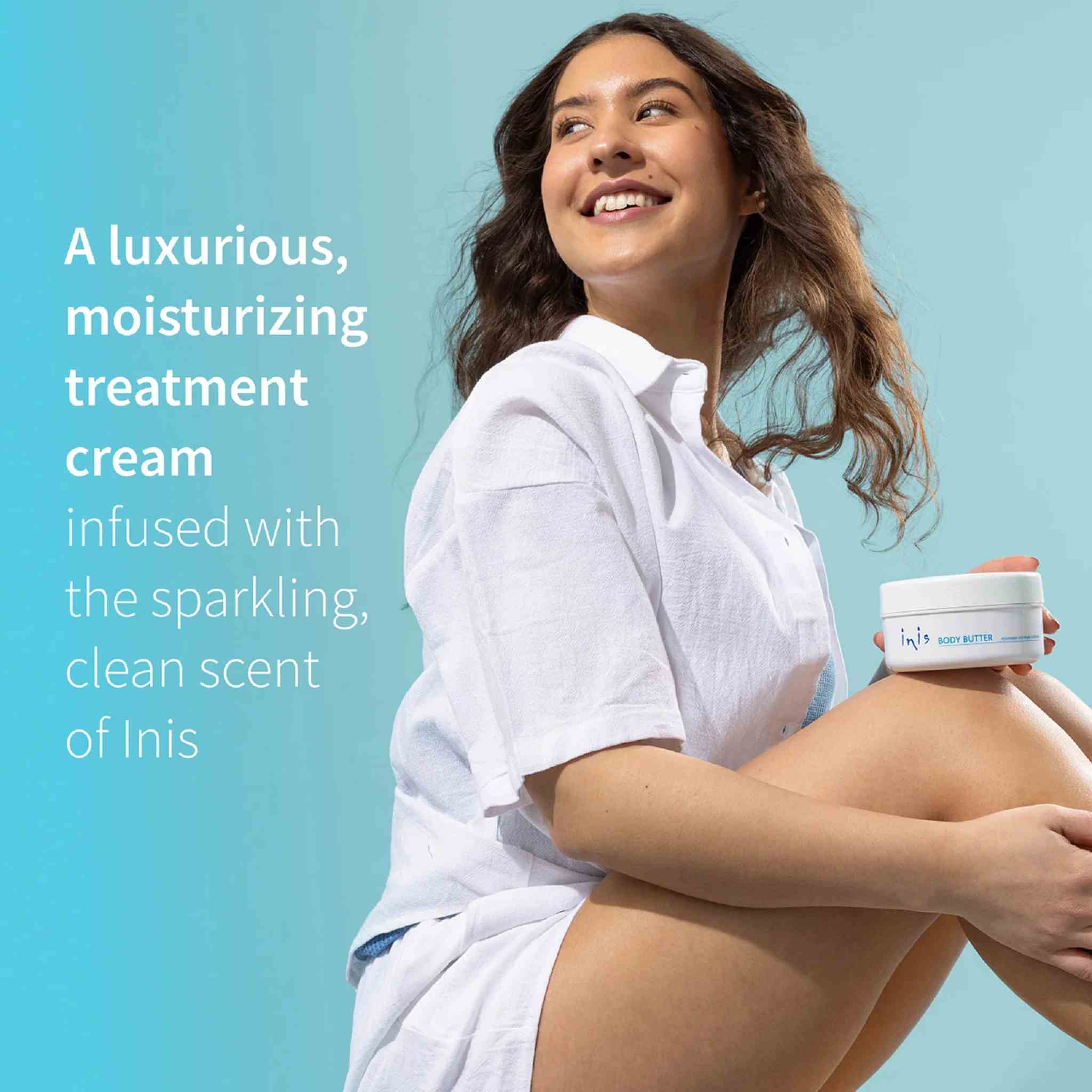 Woman holding a jar of Inis moisturizing cream against a blue background