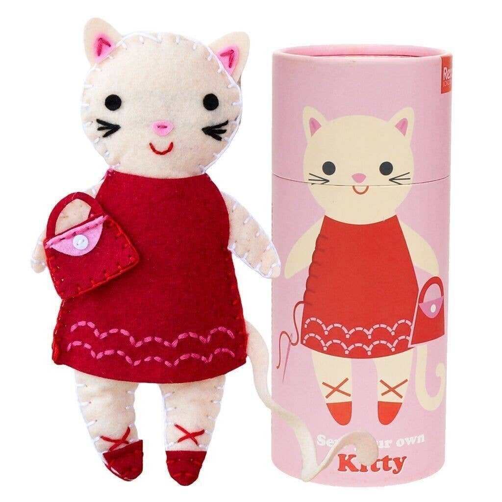 Stuffed cat toy in a red dress with a matching tube packaging on a white background