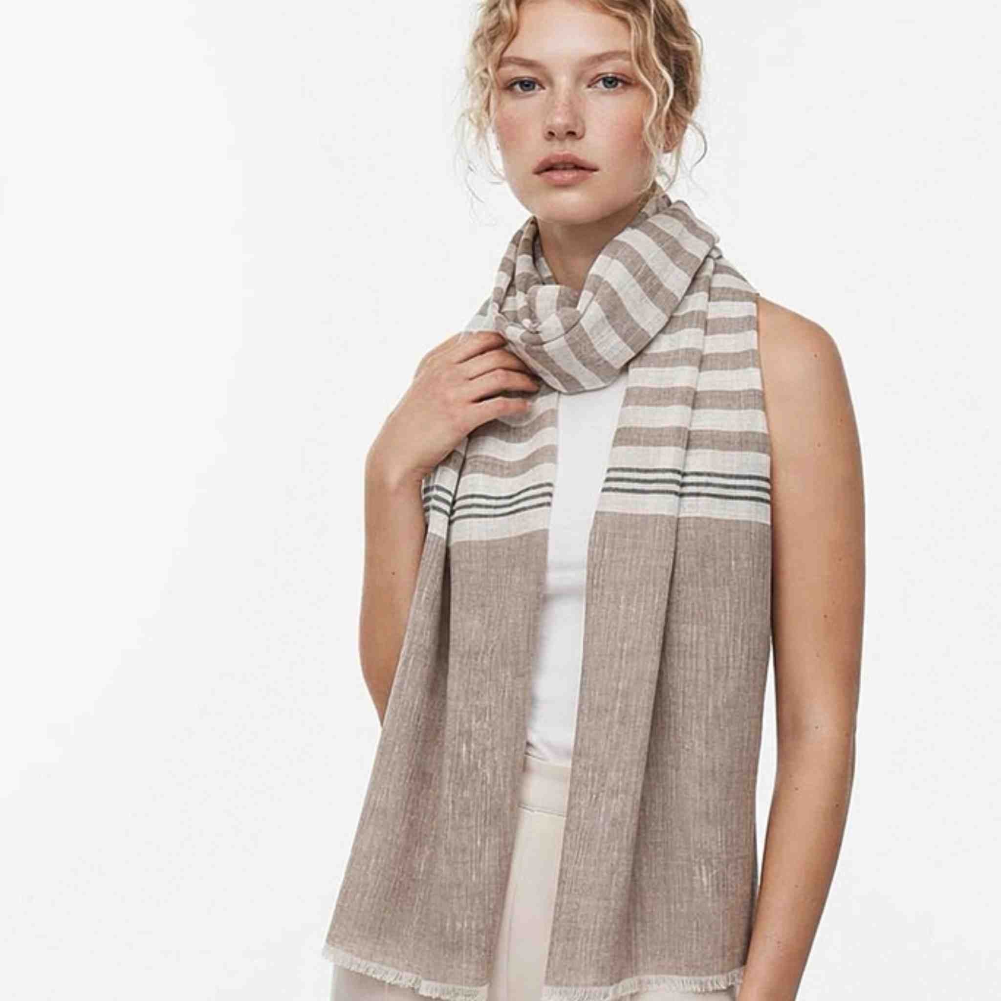 Woman wearing a striped scarf on a white background
