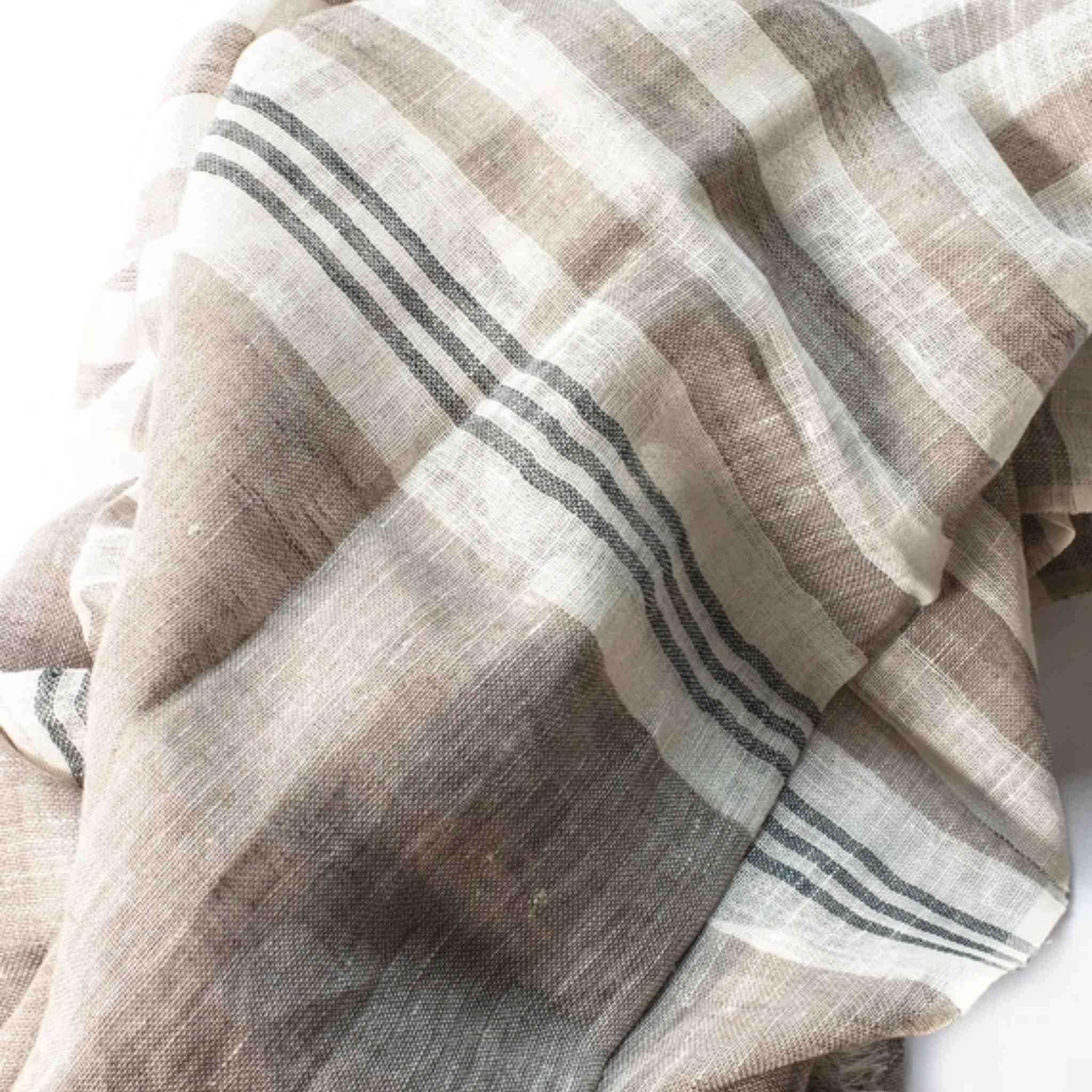Close-up of a folded scarf with striped pattern on a white background