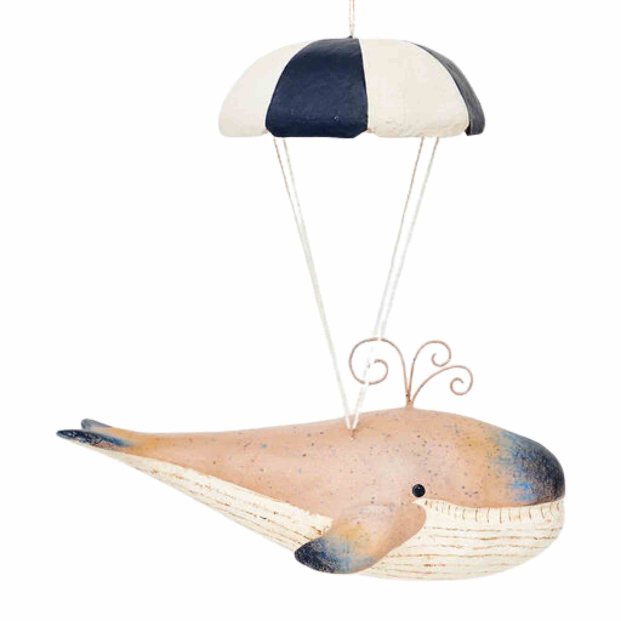 Decorative hanging whale with a striped parachute on a white background