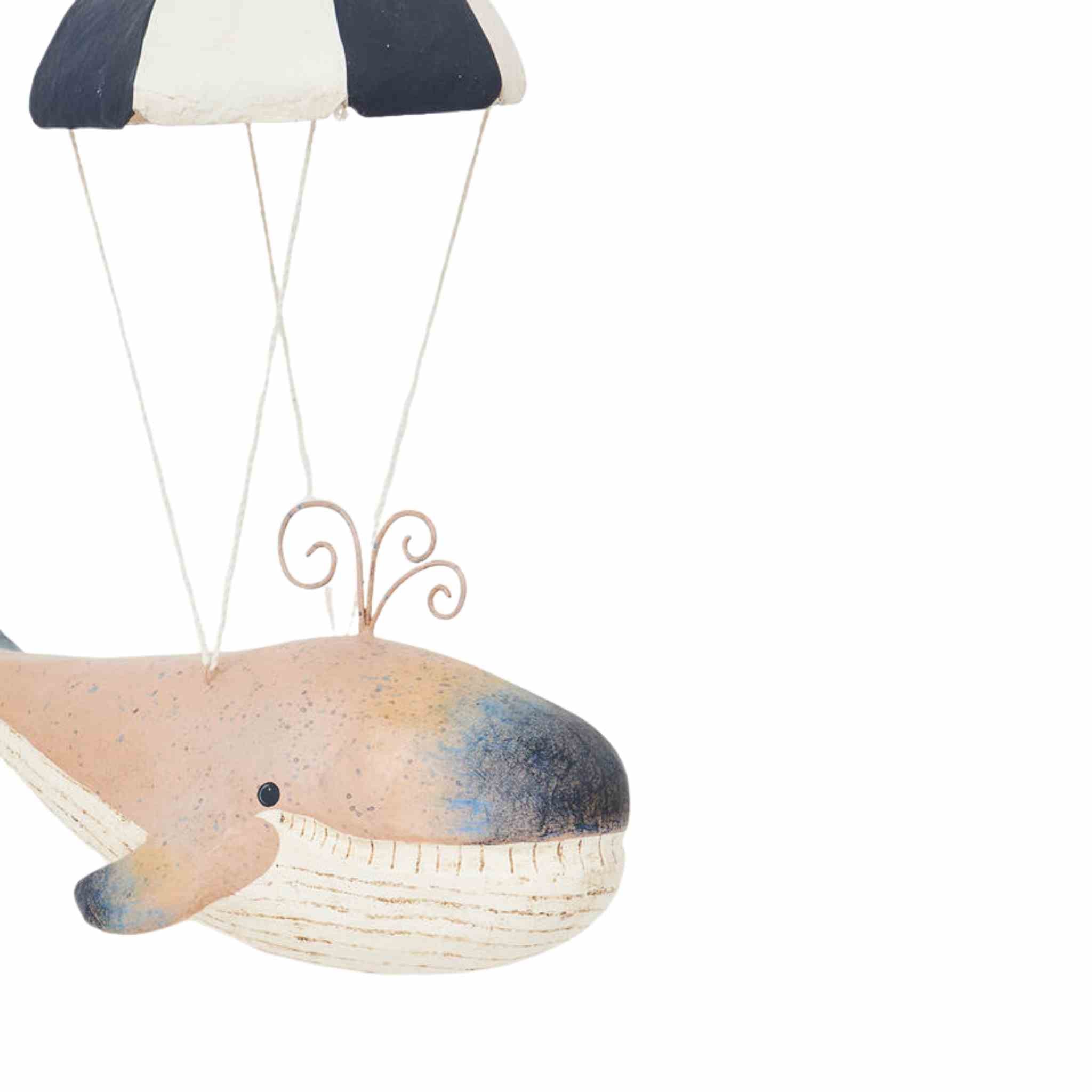 Decorative whale with a striped parachute on a white background