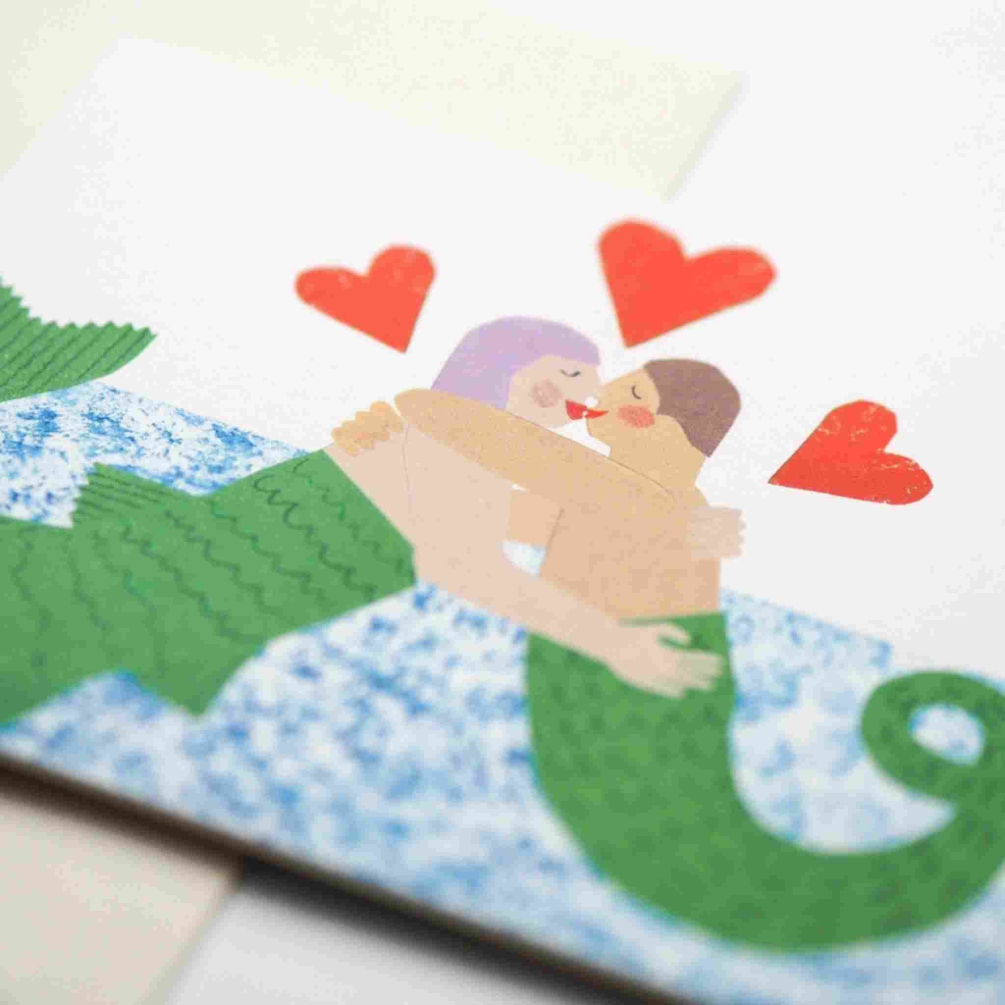 Illustration of a mermaid and a merman embracing with hearts above them, on a textured surface.
