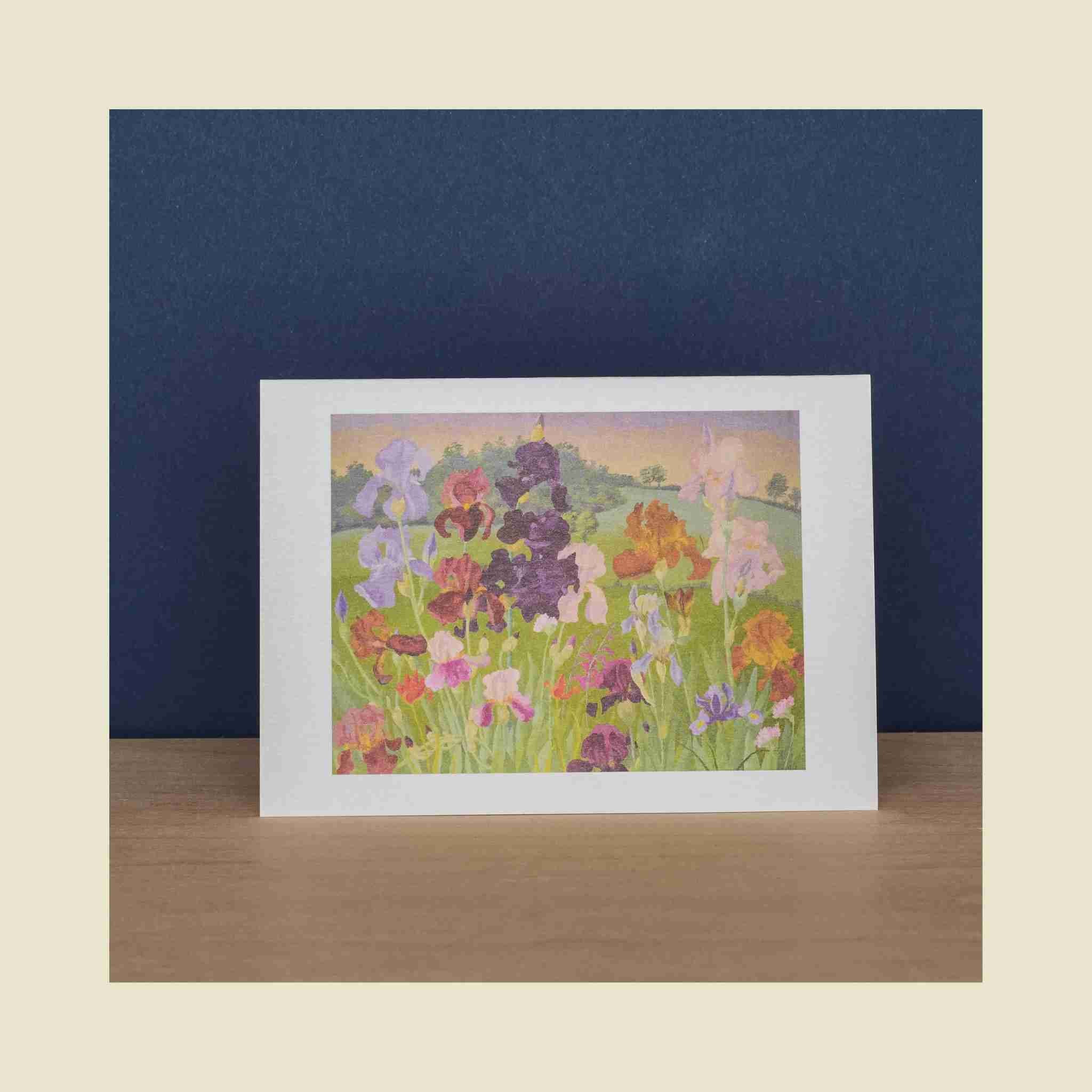 Framed artwork of colorful flowers on a wooden surface with a blue background