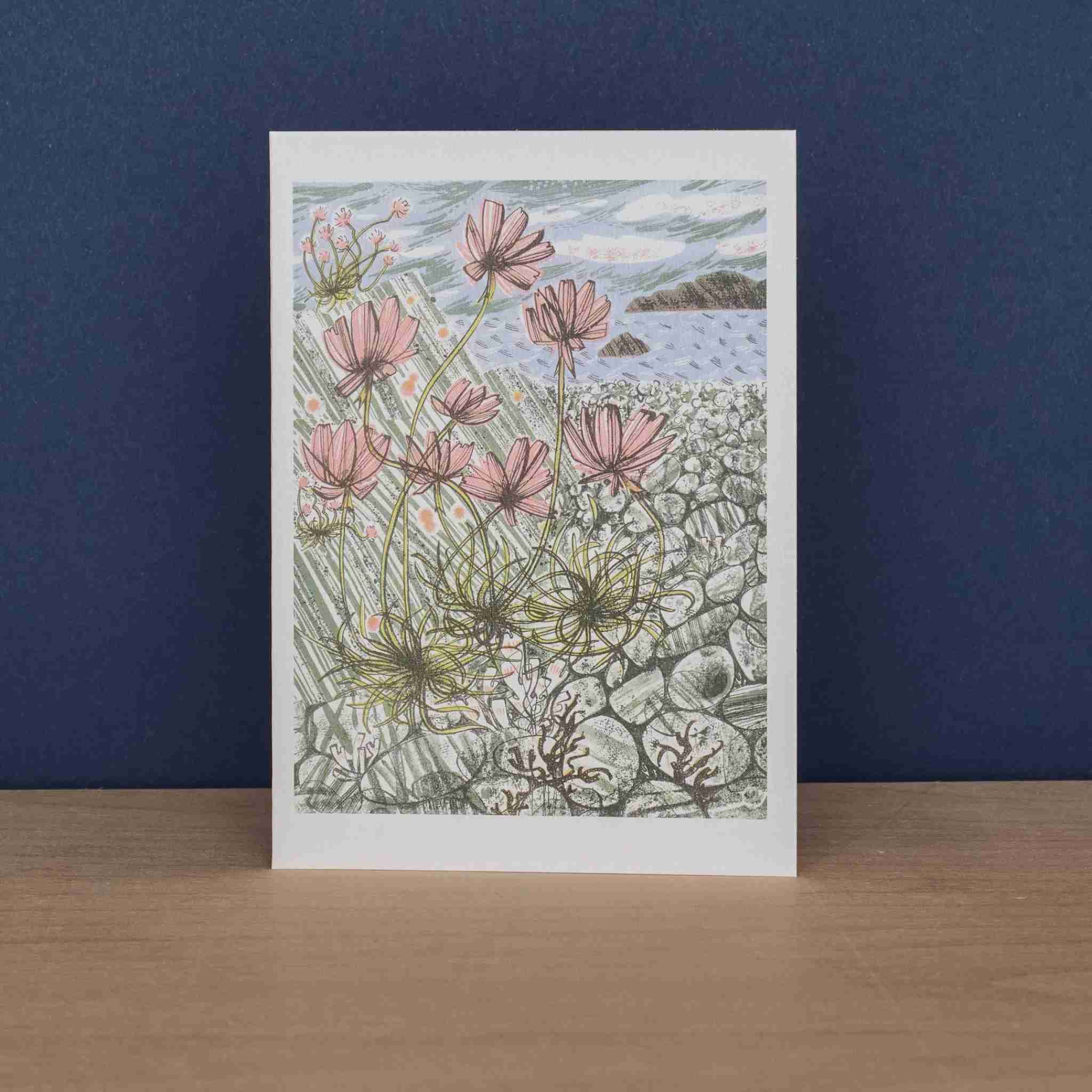 Greeting card with pink flowers and a beach scene on a white background
