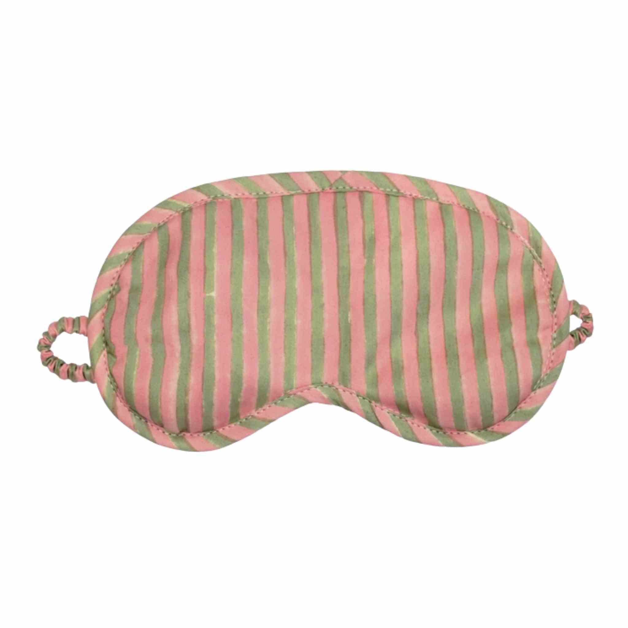 A fabric sleep mask with vertical pink and green stripes, featuring elastic strap loops on the sides, shown against a plain white background.