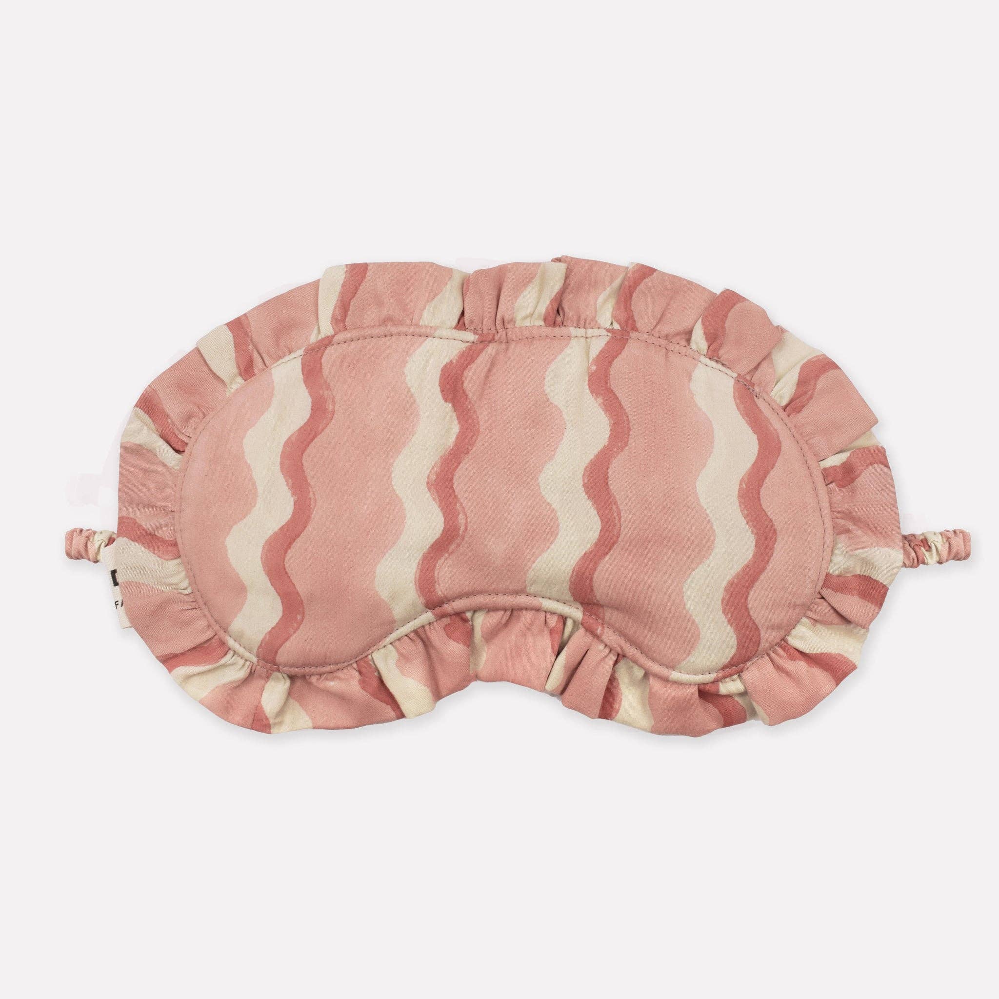 Pink and beige striped eye mask on a white background