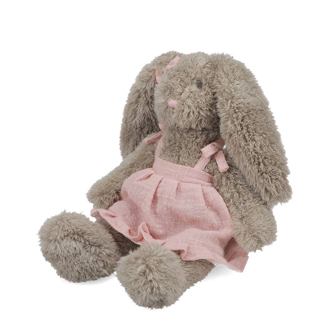 Plush rabbit toy wearing a pink dress on a white background