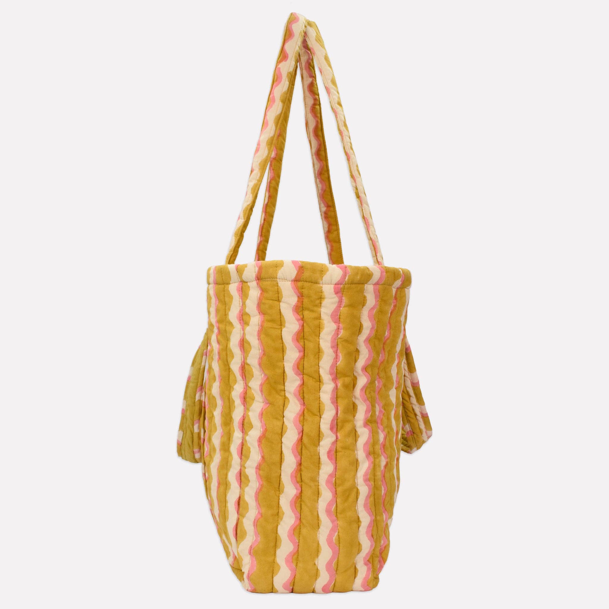 Striped bag with yellow and pink pattern on a white background