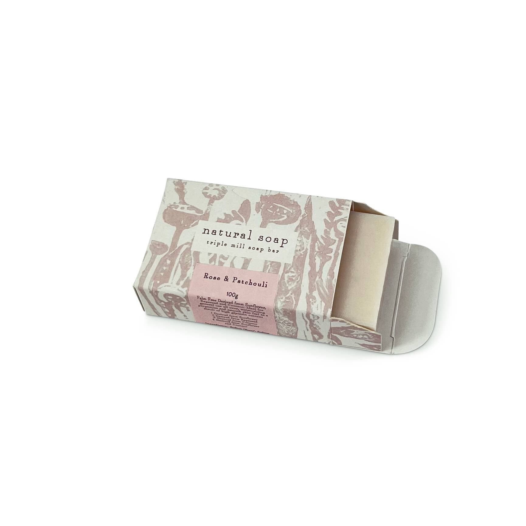 Bar of soap in a decorative box with floral design on a white background