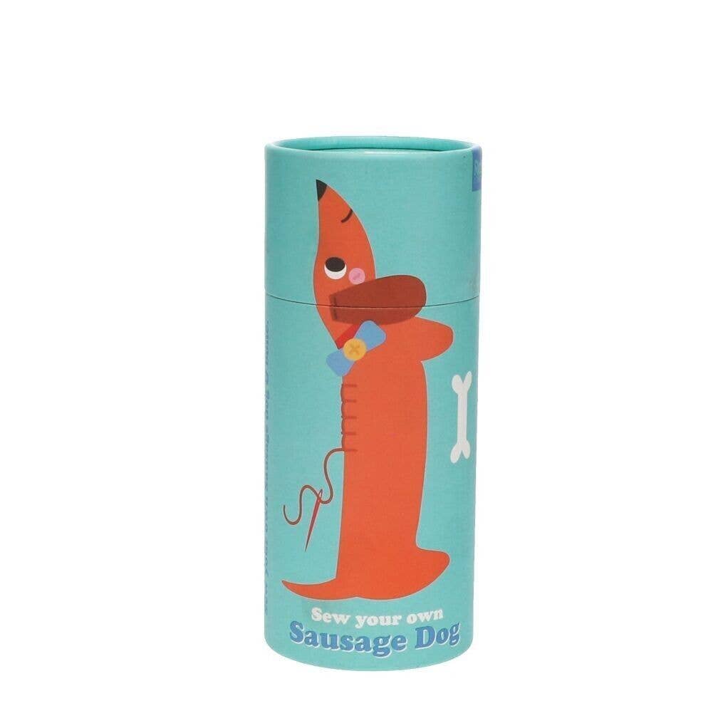  cylindrical craft kit packaging with a sausage dog illustration on a white background