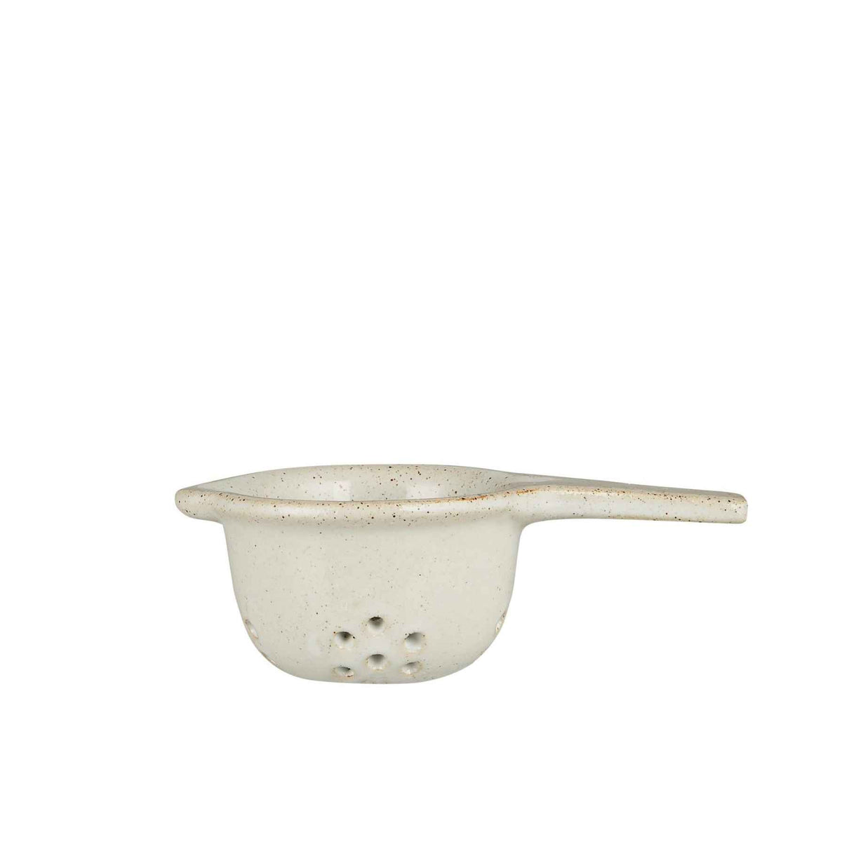 A small ceramic strainer with a single handle and perforated bottom, featuring a speckled off-white glaze with subtle brown undertones, set against a plain white background.
