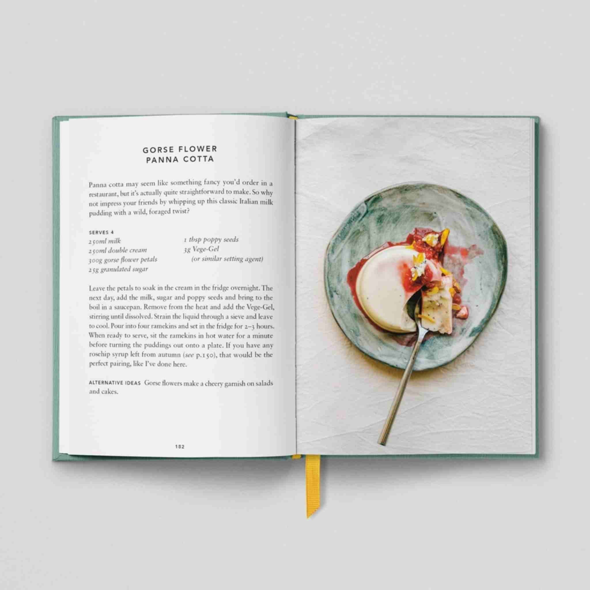 Open book with a recipe for 'Gorse Flower Panna Cotta' and an image of the dish on a plate.