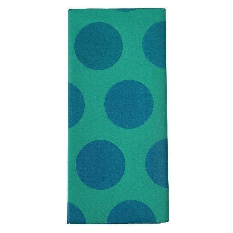Green towel with large blue polka dots on a white background