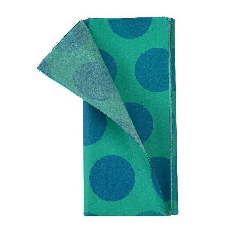 Green towel with blue polka dots on a white background