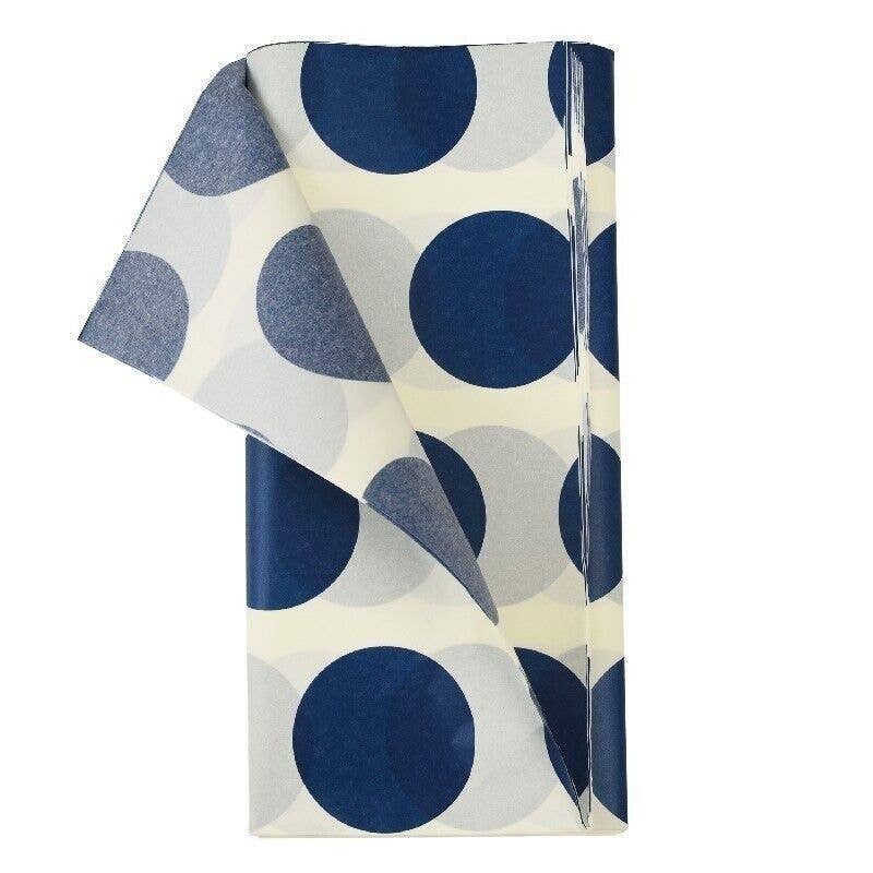Folded tissue paper with blue polka dot pattern on a white background