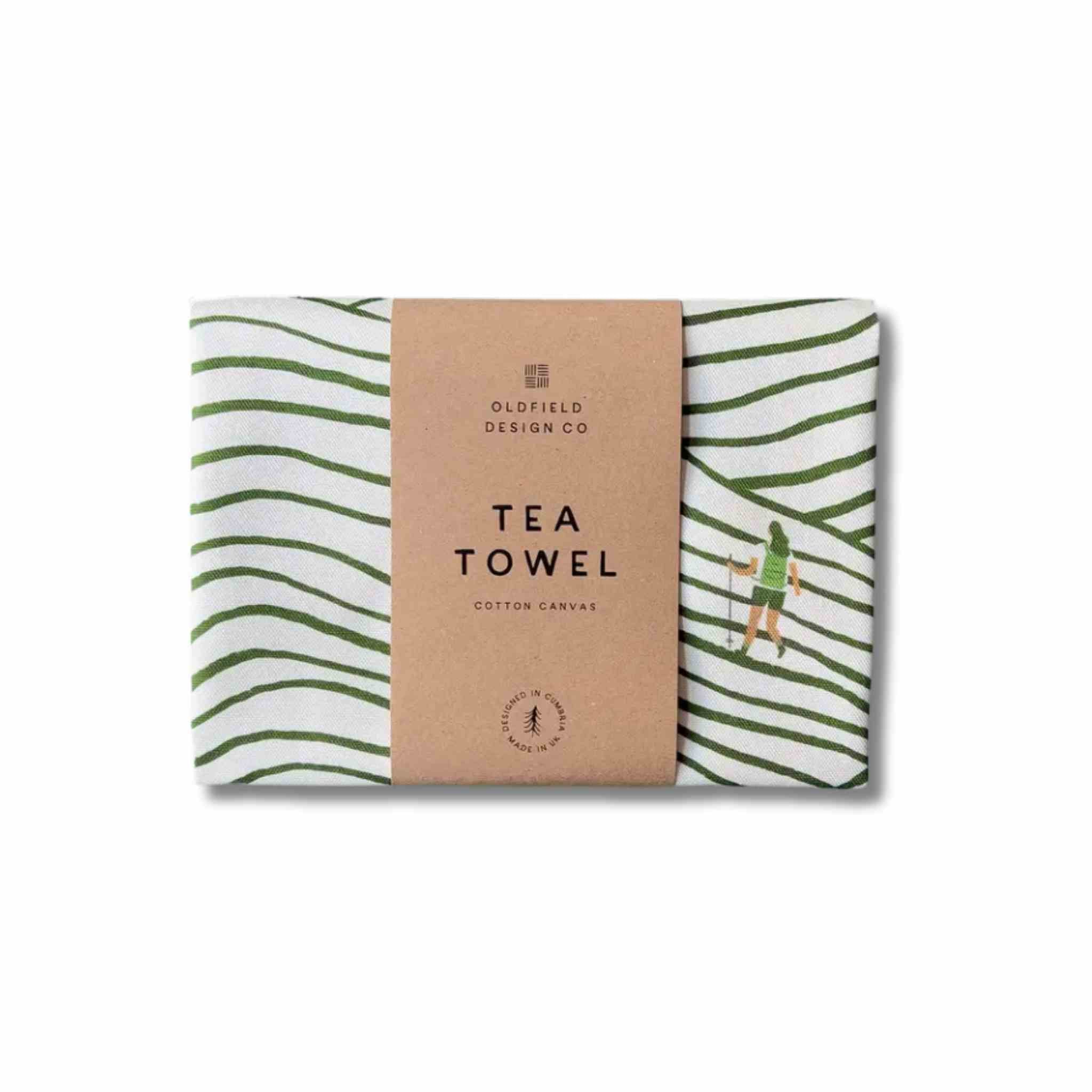 Tea towel with green stripes and a kraft sleeve labeled 'Oldfield Design Co' on a white background