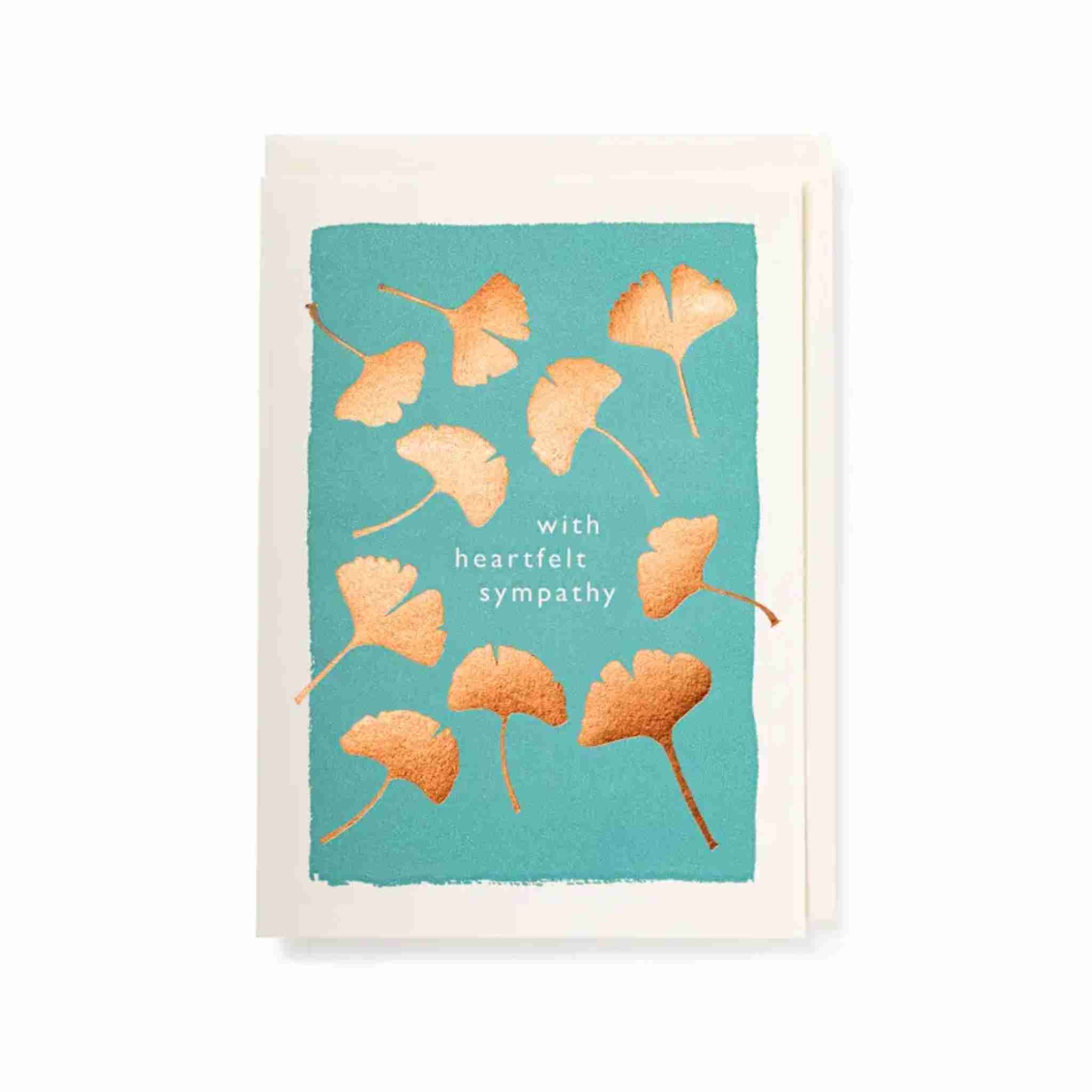Sympathy card with ginkgo leaves on a teal background