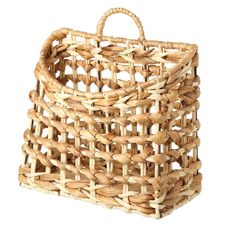 Woven rattan basket with a handle on a white background
