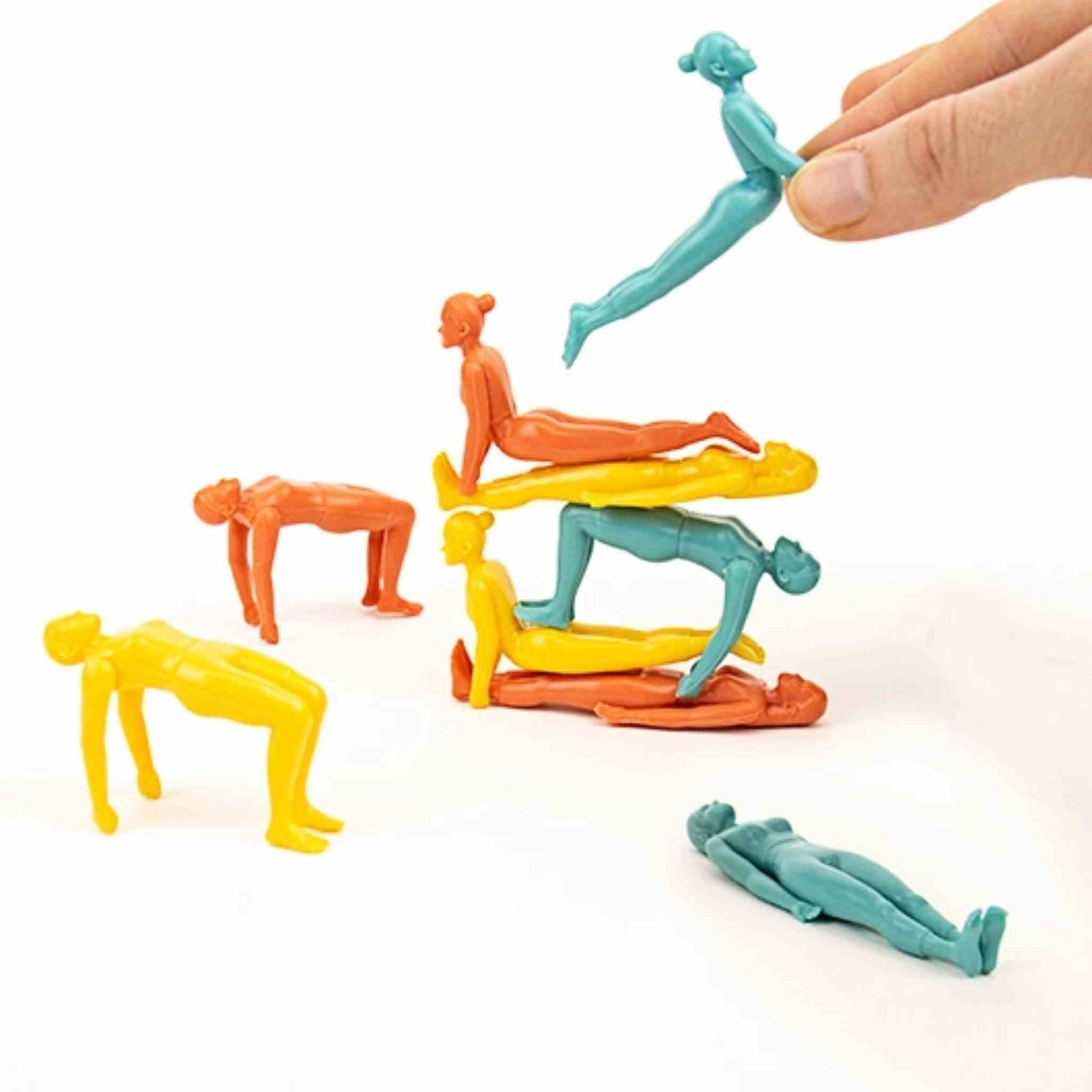Colorful plastic figures of people in various poses on a white background