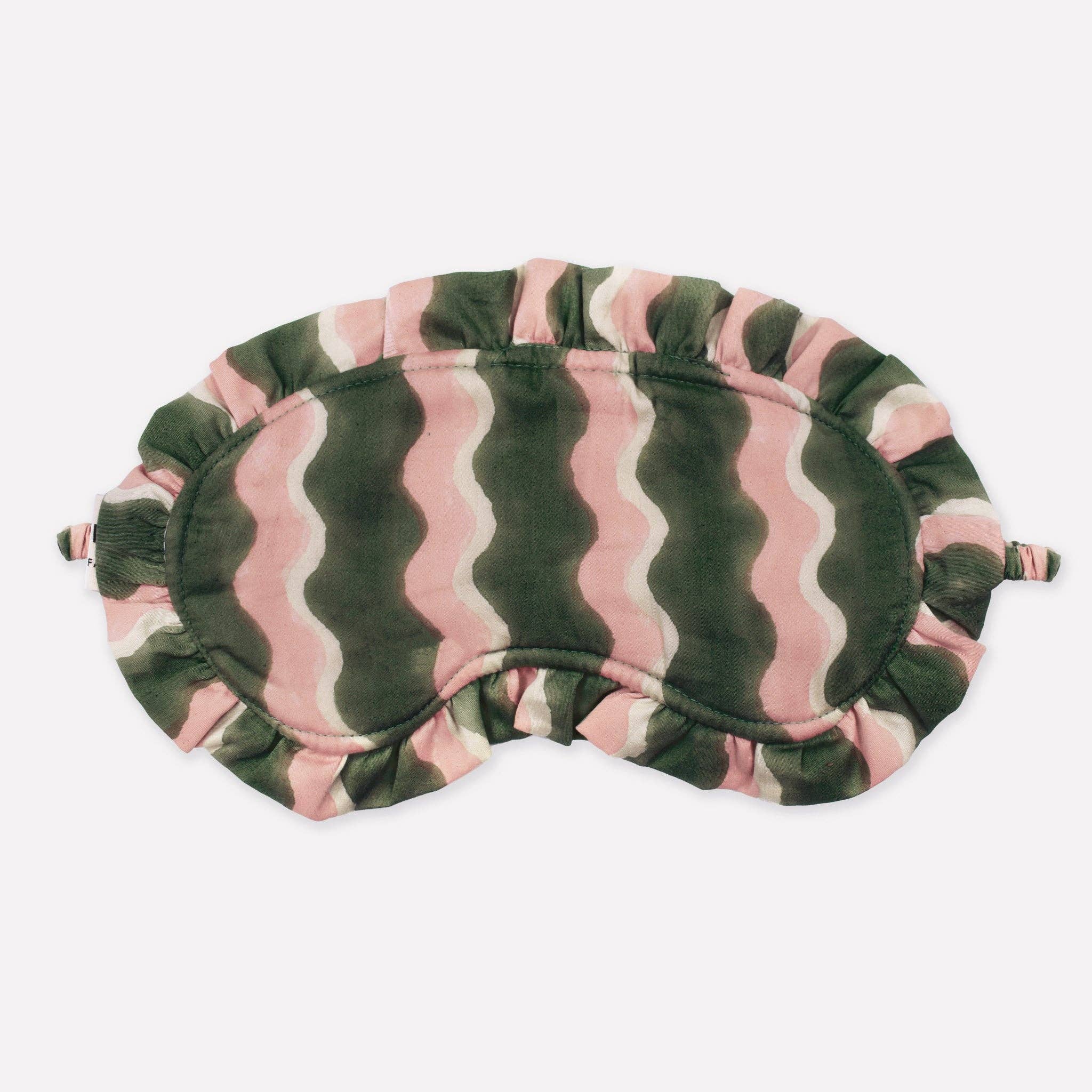 Eye mask with pink and green wave pattern on a white background