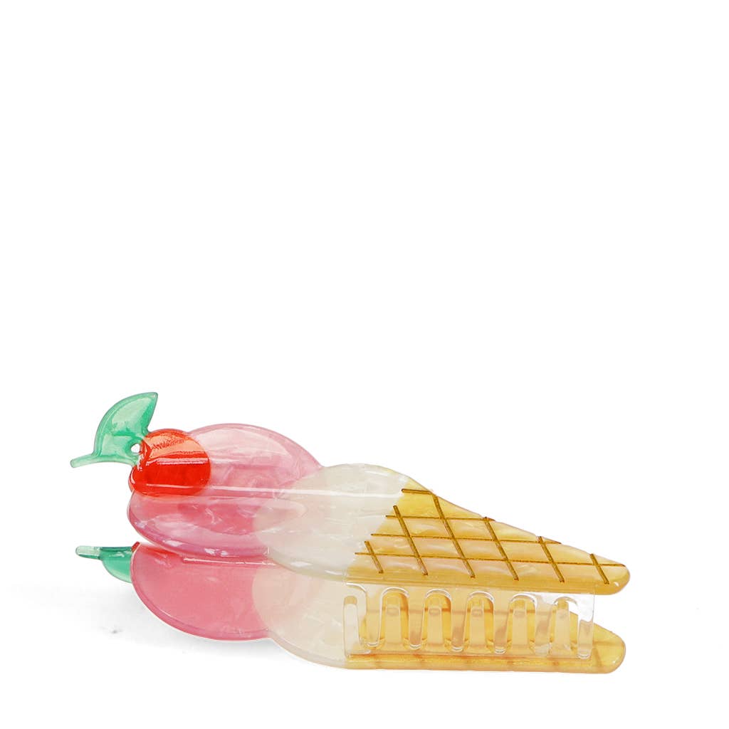 hair claw in shape of icecream cone with a cherry on top on a white background