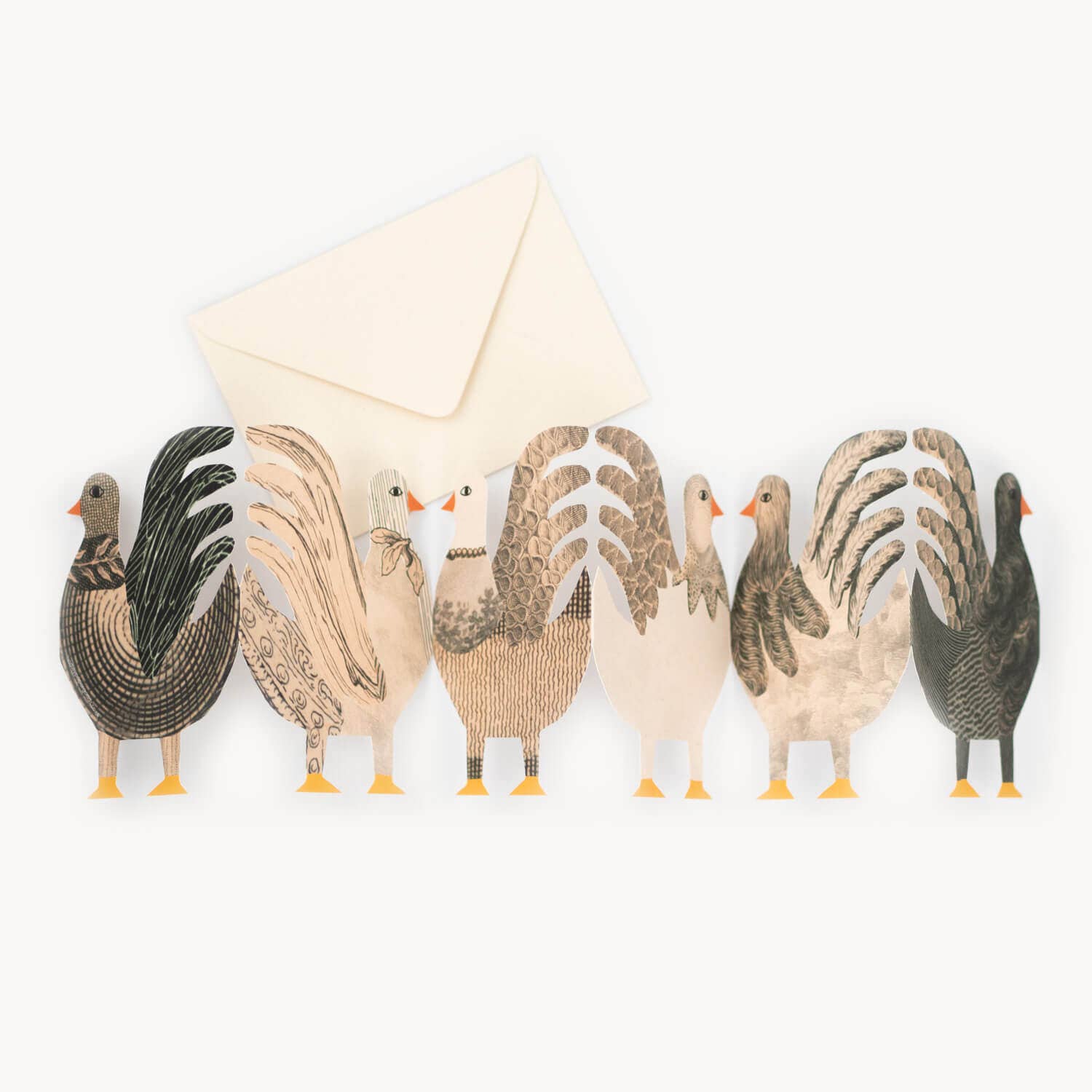 Set of decorative rooster figurines with a white envelope on a white background